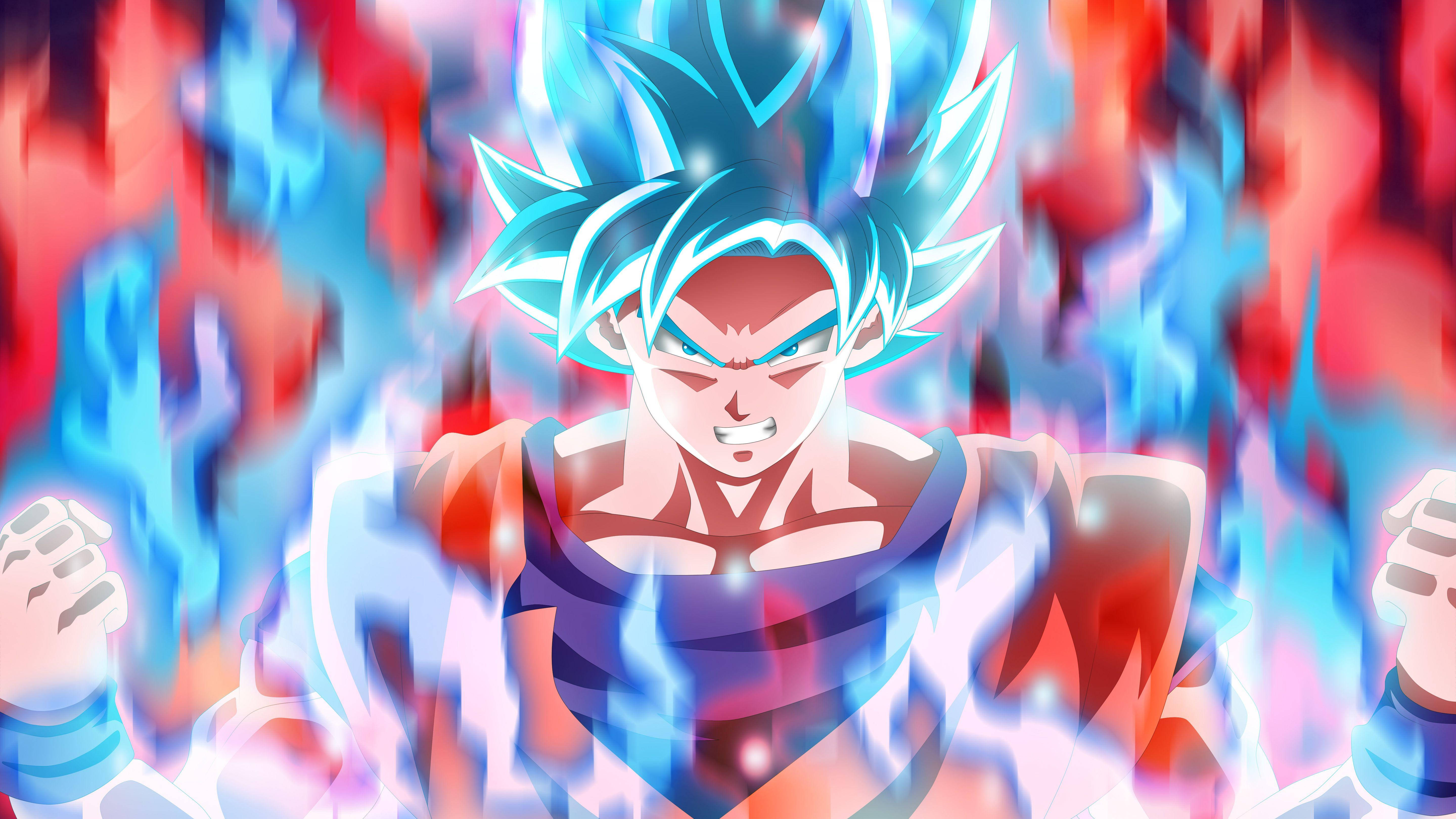 Goku Dragon Ball Super 桌布 壁紙 — 動漫角色悟空以超級賽亞人藍色形態出現，帶有發光的藍色頭髮和光環，被紅色和藍色的能量火焰包圍。
