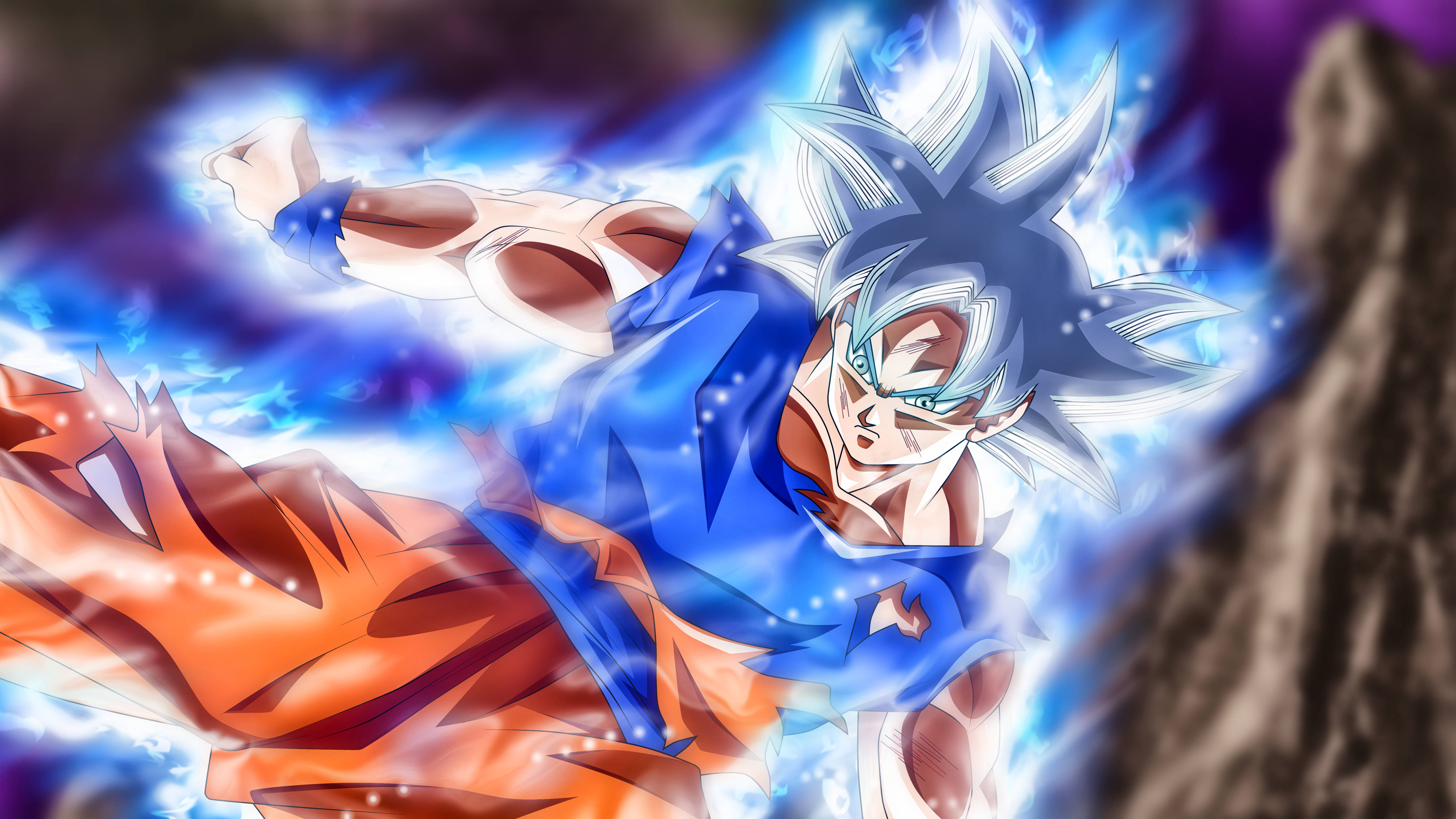 Ultra Instinct Goku 桌布 壁紙 — 動漫角色悟空以超級賽亞人藍色形態，在黑暗岩石背景下釋放出強大的藍色能量爆炸。