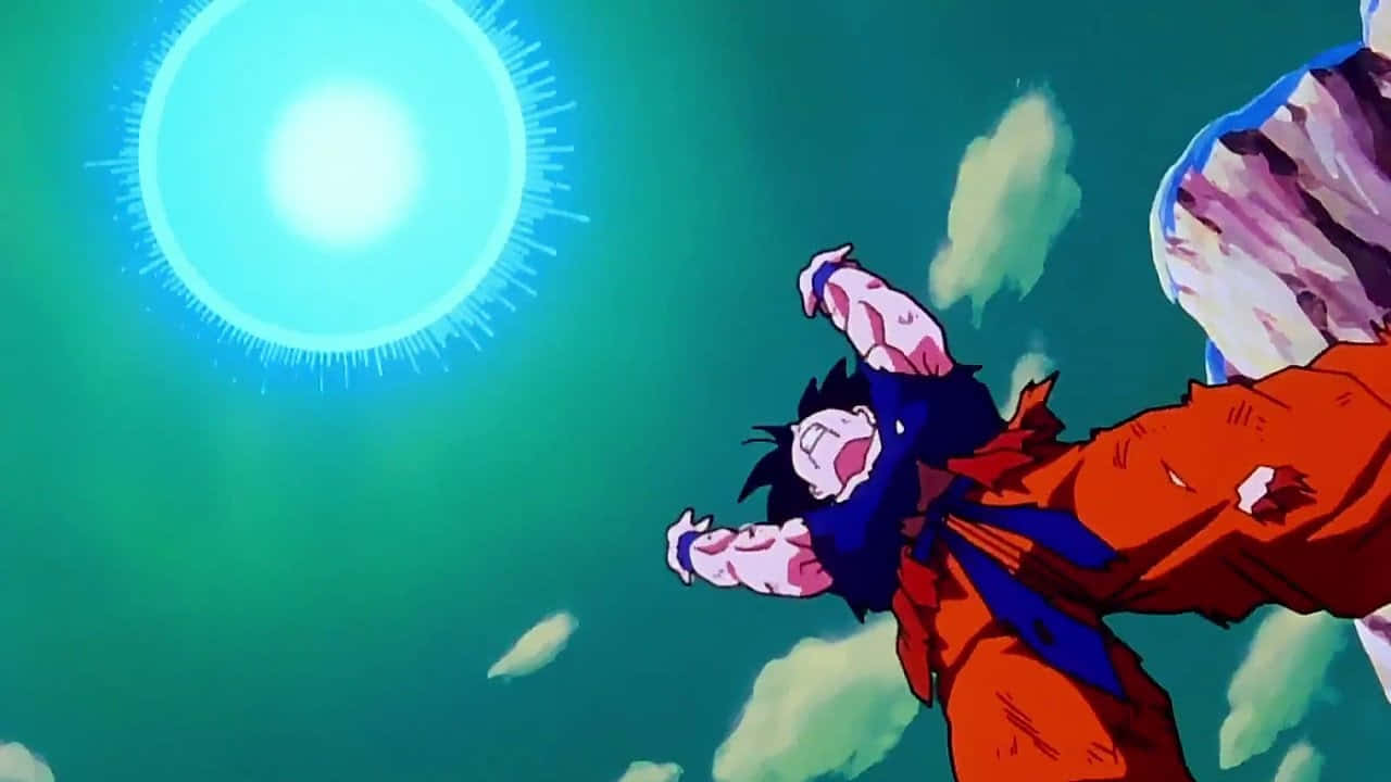 Goku's Spirit Bomb Sword 桌布 壁紙 — 動漫角色悟空穿著橙色道服，在漂浮的岩石碎片中穿過青綠色的天空，朝發光的藍色能量球飛躍。