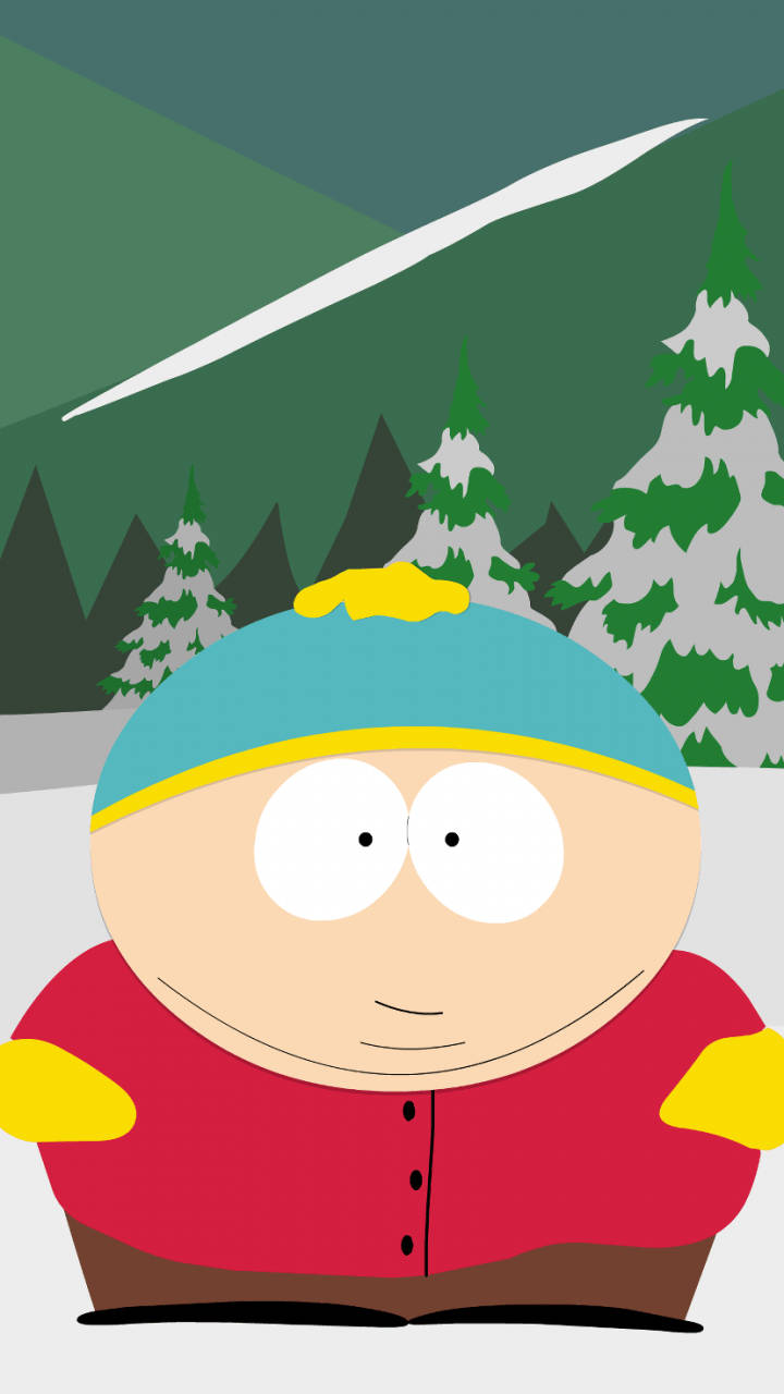 Cartman 桌布 壁紙 — 卡通男孩穿著紅色外套和藍色帽子，站在雪地森林中，背景是白雪覆蓋的松樹和綠色的山脈。