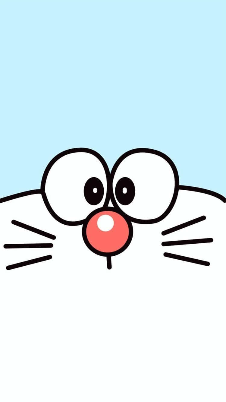 Doraemon 桌布 壁紙 — 卡通貓的臉，有大眼睛和紅鼻子，從底部窺視，背景是淺藍色。