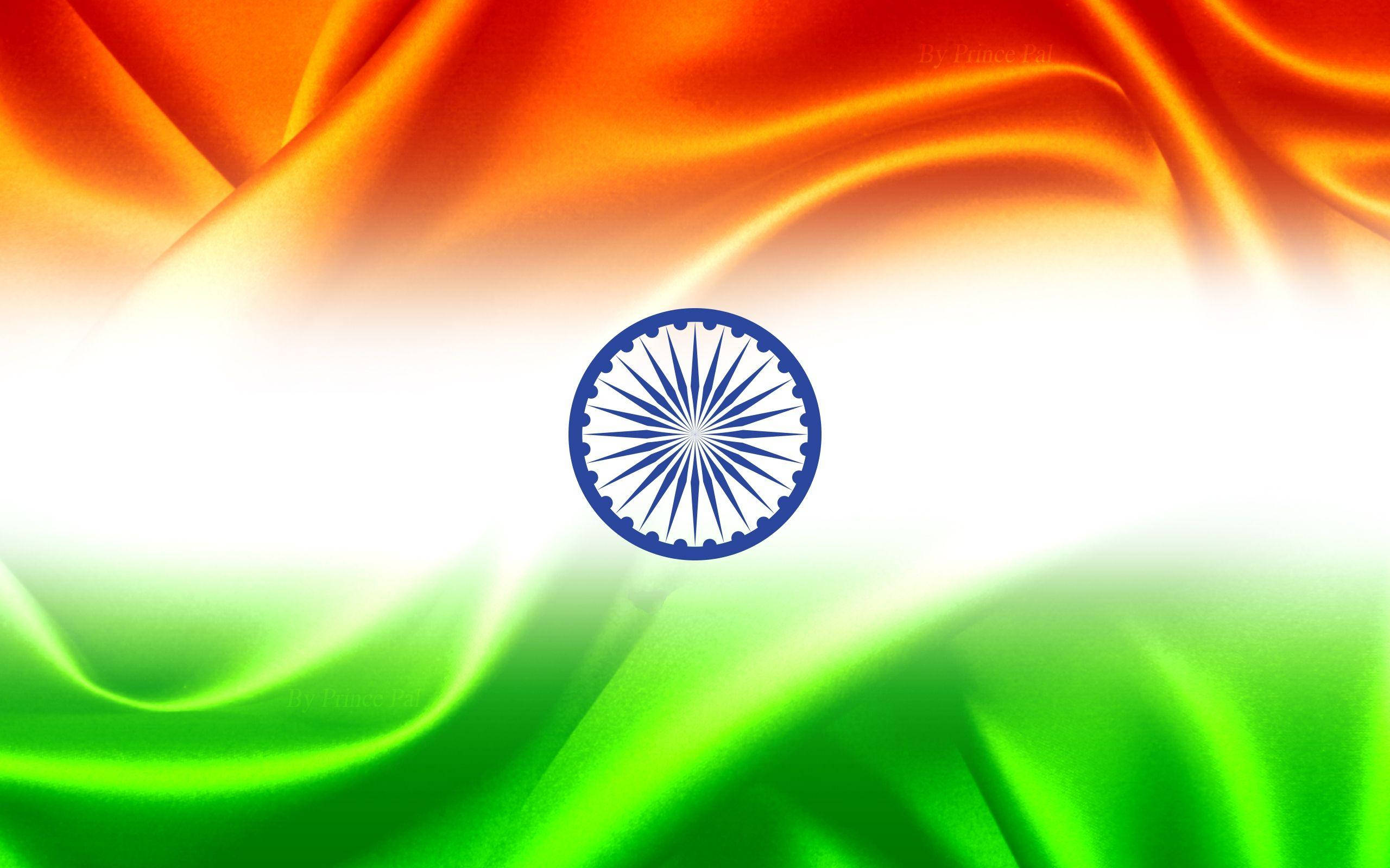Indian 桌布 壁紙 — 印度國旗動態飄揚，帶有鮮豔的藏紅花、白色和綠色條紋，中央是海軍藍色的阿育王法輪。