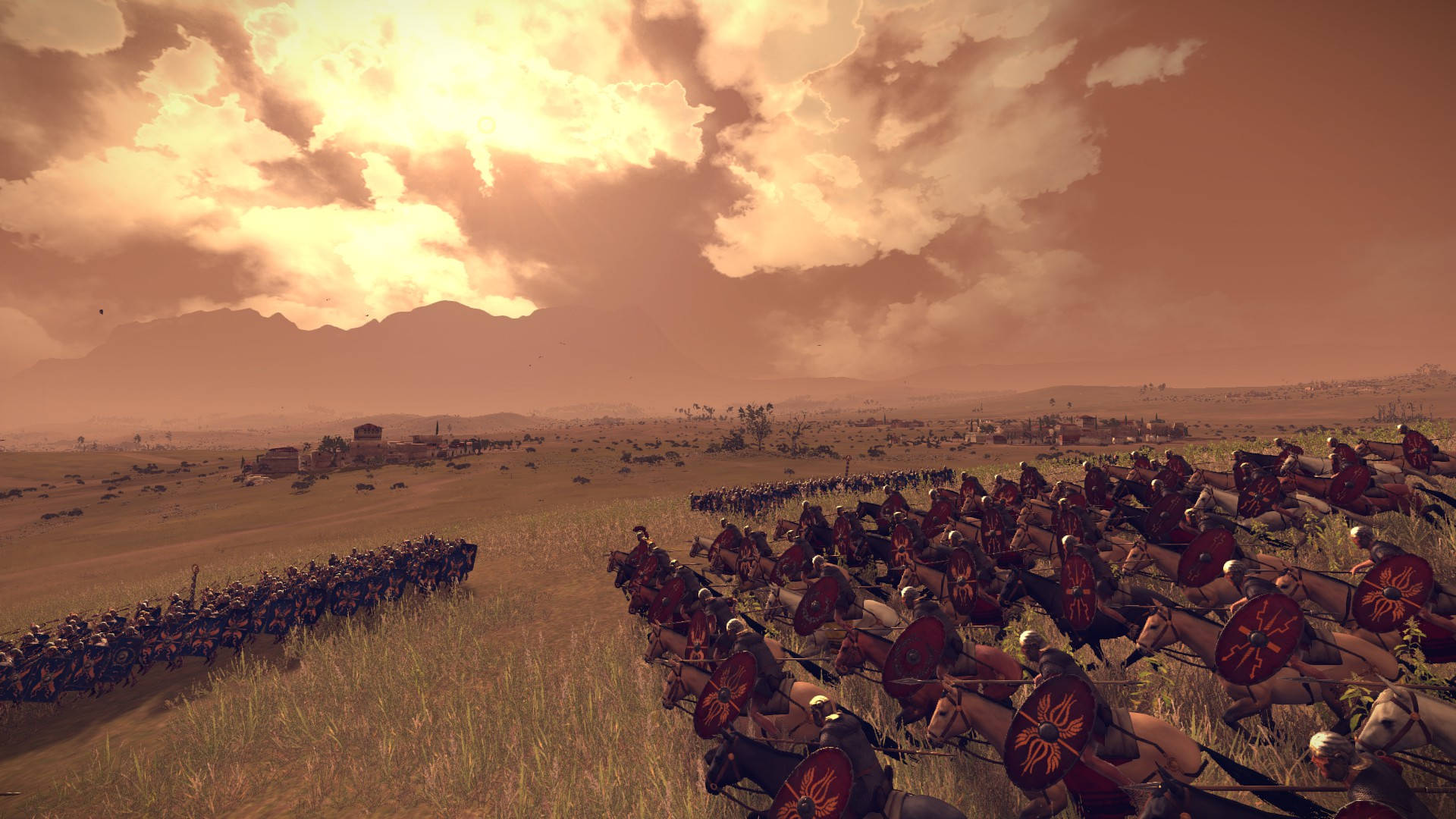 Rome 2 Total War 桌布 壁紙 — 古代騎兵和步兵部隊在廣闊的金色田野中交戰，背景是戲劇性的日落天空和遠處的山脈。