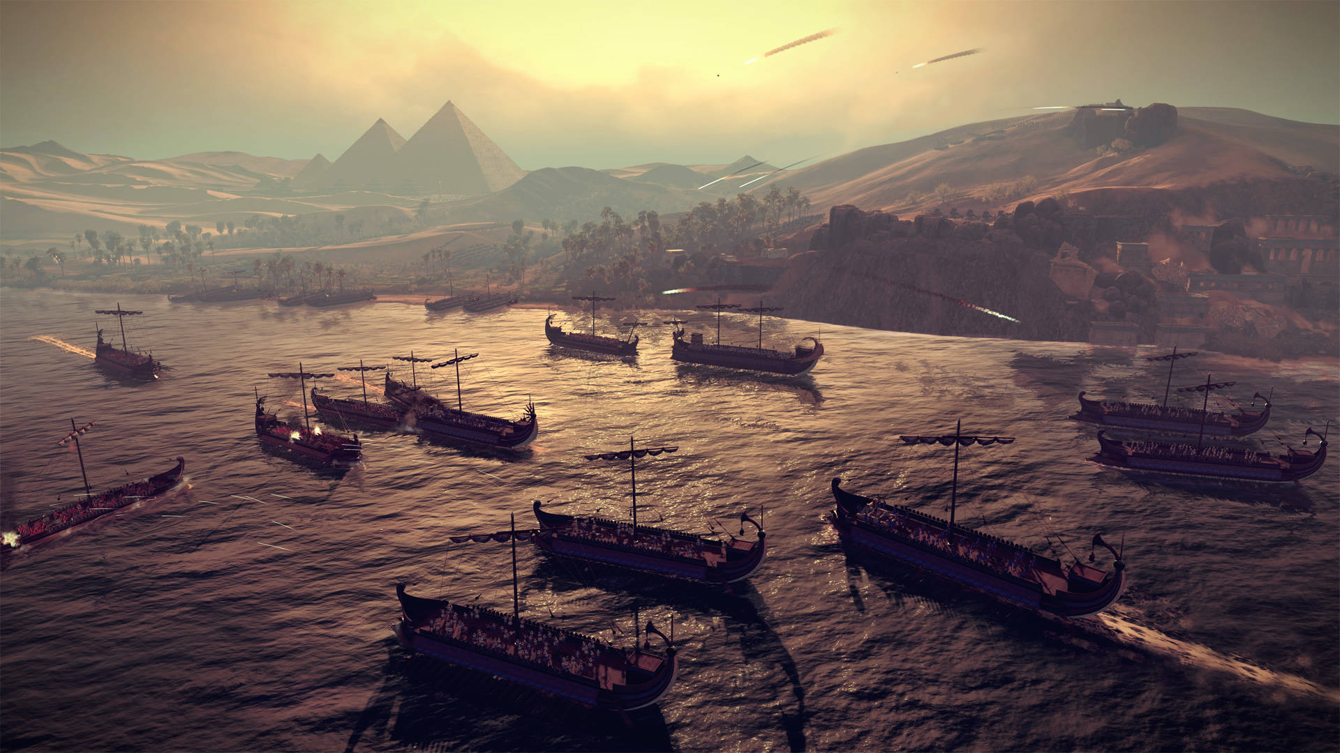 Total War 桌布 壁紙 — 古埃及戰船在金色的河流上航行，金字塔在夕陽朦朧的遠方升起。
