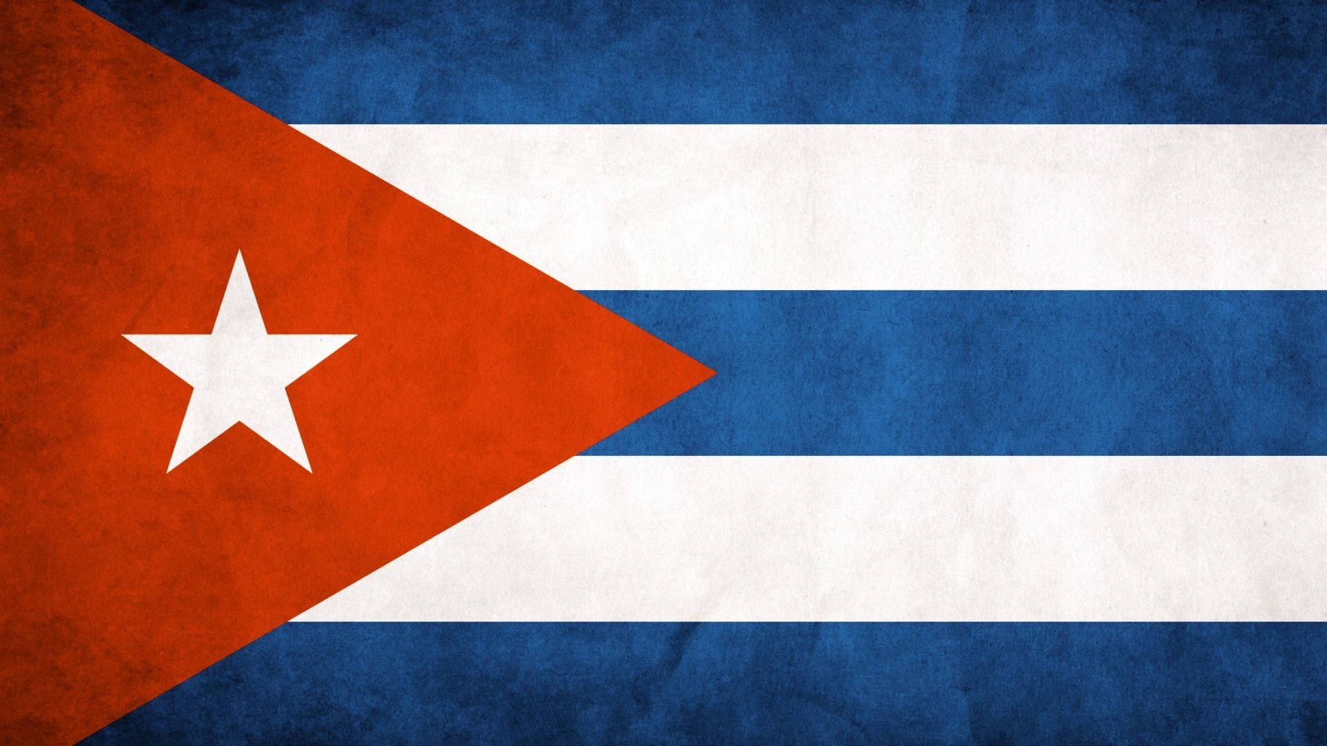 Cuba 桌布 壁紙 — 古巴國旗，帶有紅色三角形、白色星星和藍白條紋，質感如舊布料。