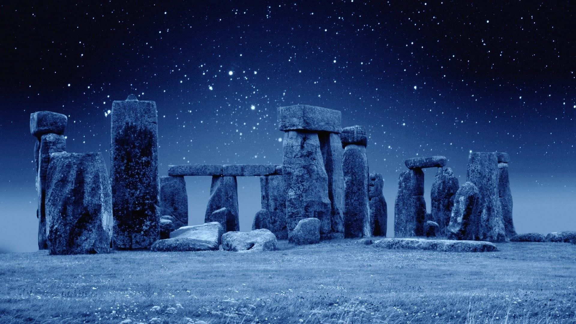 winter solstice 桌布 壁紙 — 古老的石圈在沐浴著冷藍色調的星空夜空下莊嚴地矗立。