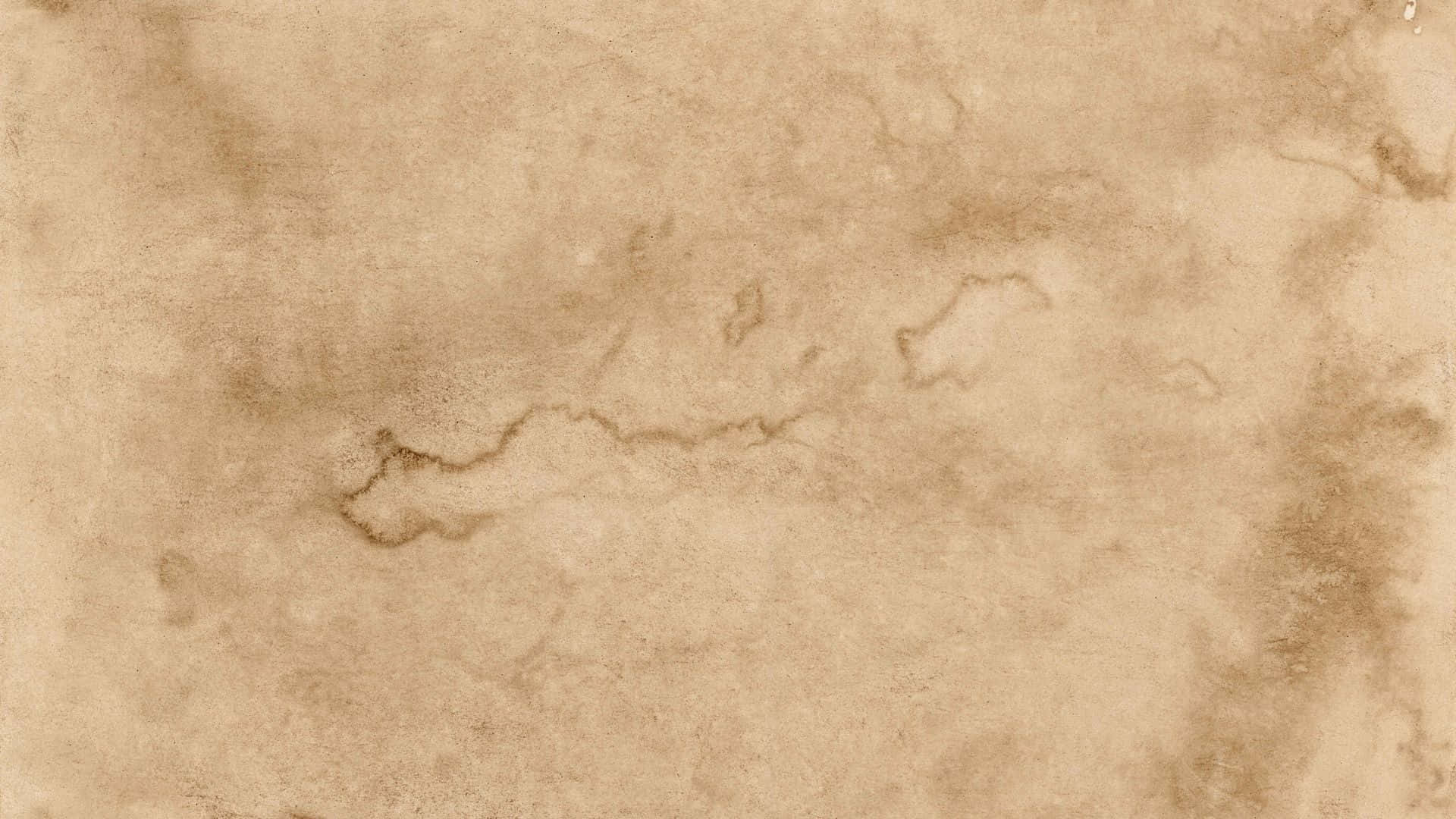 Old Paper Texture 桌布 壁紙 — 古老羊皮紙的特寫，帶有微妙的棕色污漬和有機紋理。