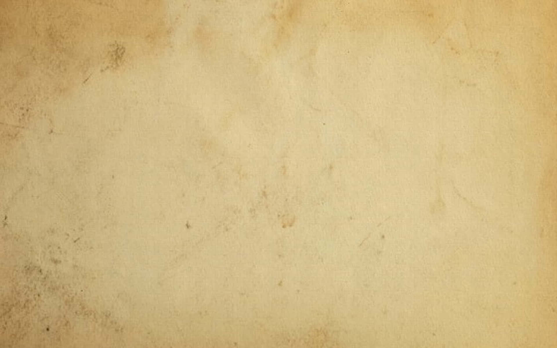 Old Paper 桌布 壁紙 — 古老羊皮紙的特寫，帶有微妙的污漬和溫暖米色調的紋理變化。