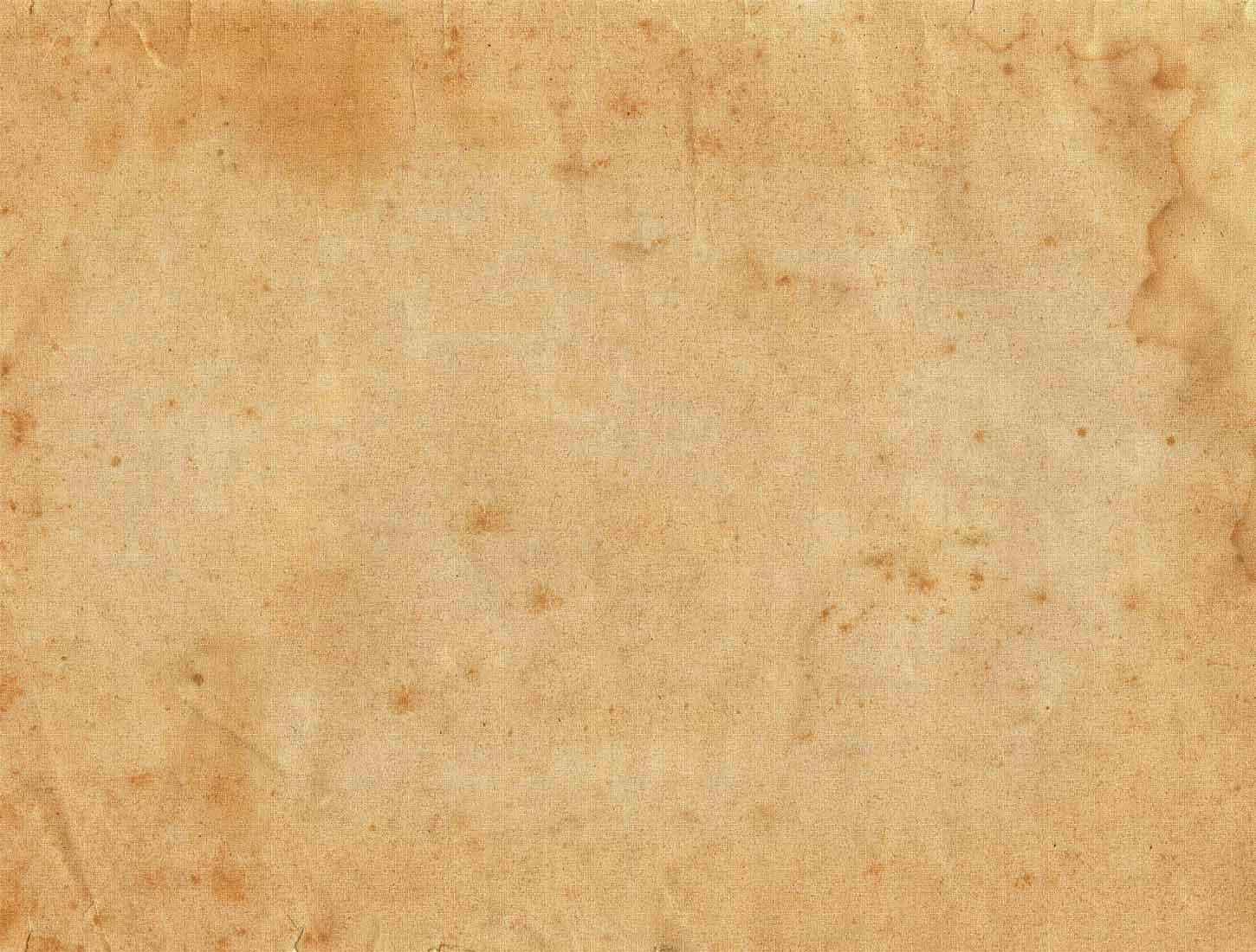 Old Paper 桌布 壁紙 — 古老羊皮紙的特寫，帶有自然棕色污漬和細微的紋理變化。
