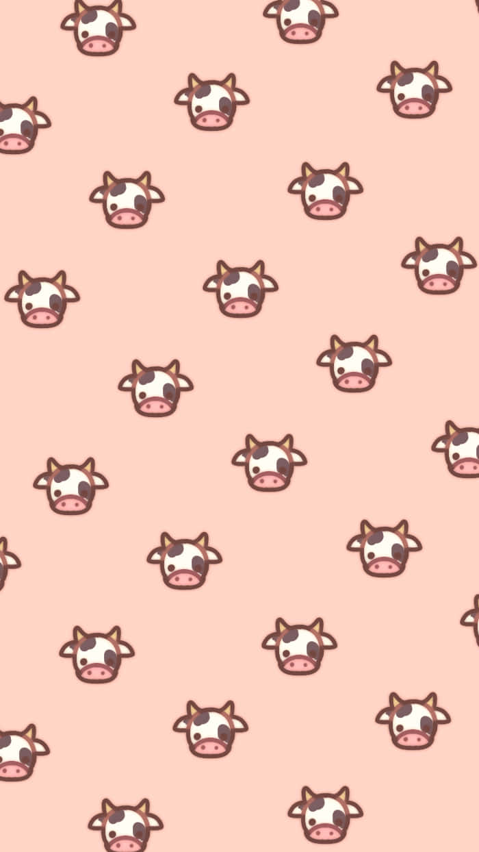 Kawaii Cow 桌布 壁紙 — 可愛的黑白卡通牛頭，帶有粉紅色鼻子，散佈在柔和的蜜桃色背景上。