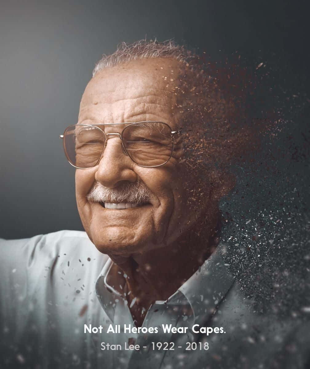 Stan Lee Tribute 桌布 壁紙 — 史丹·李溫暖地微笑，他的右側在深灰色背景上分解成閃爍的粒子。