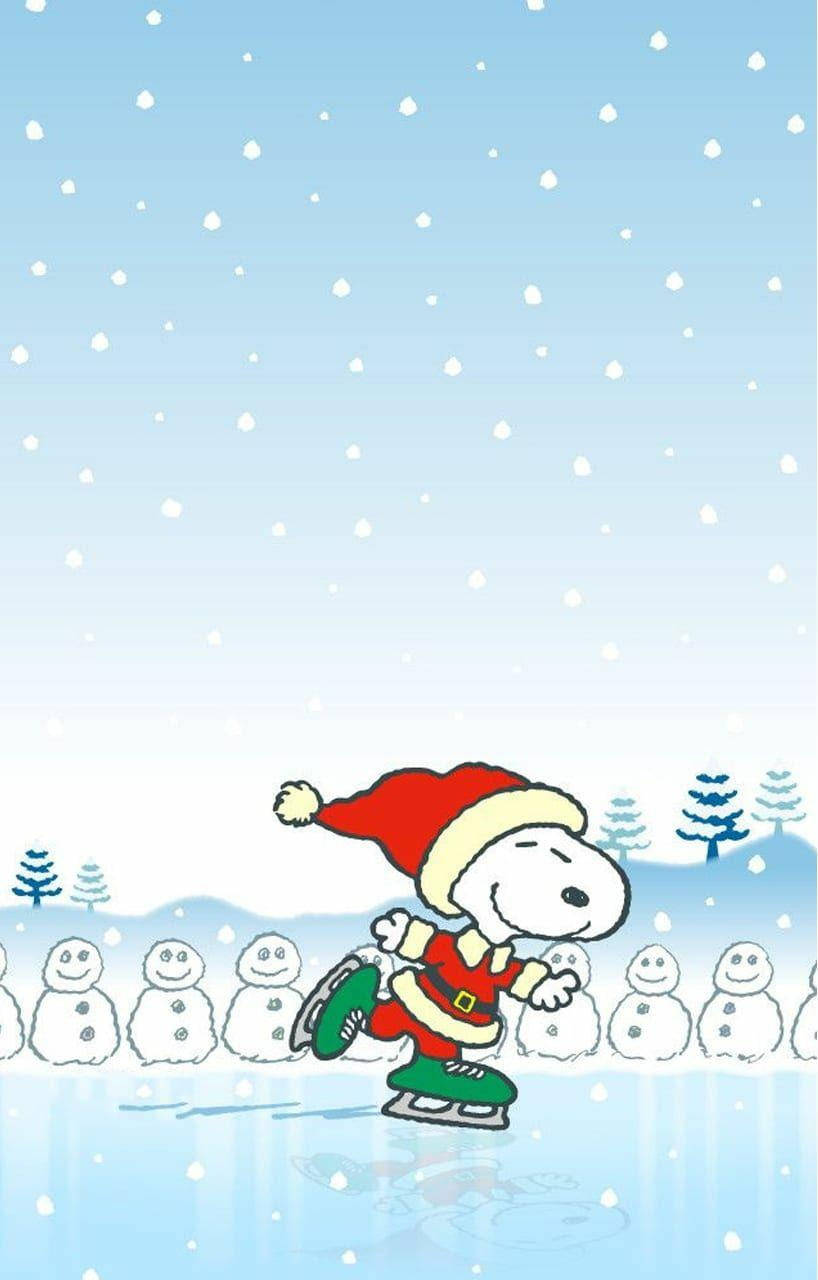 Snoopy Christmas 桌布 壁紙 — 史努比戴著紅色聖誕帽和穿著紅色聖誕套裝，在飄雪中溜冰經過微笑的雪人。