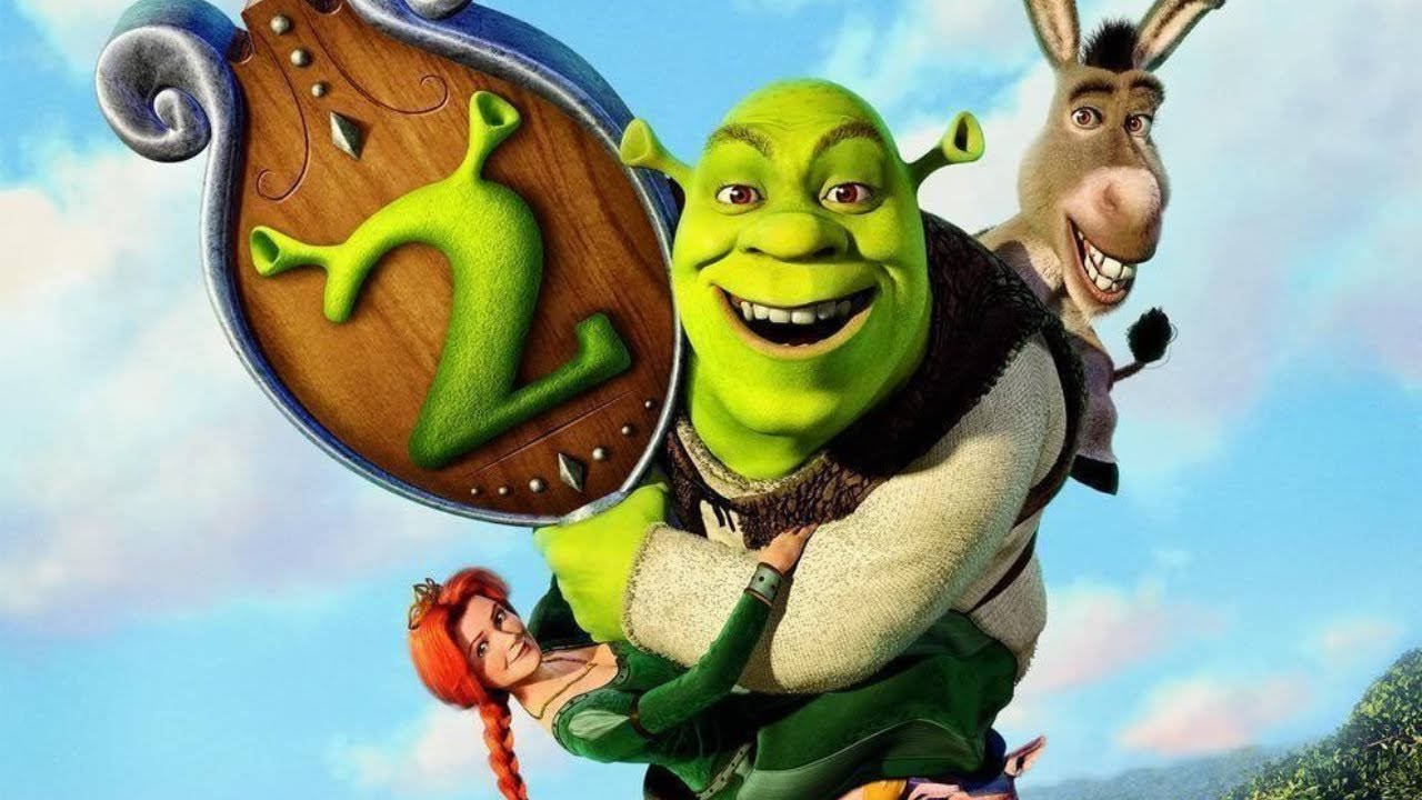 Shrek 2 桌布 壁紙 — 史瑞克和驢子高興地將費歐娜抬在一個帶有綠色數字二的盾牌上，背景是明亮的藍天。