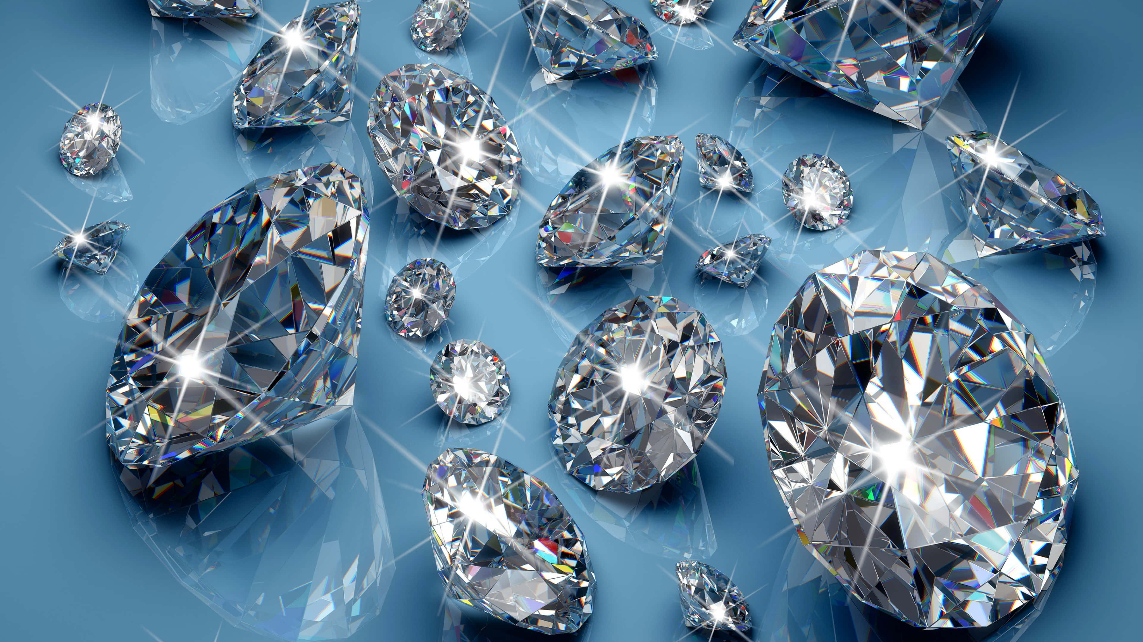 diamonds 桌布 壁紙 — 各種切割的閃爍鑽石在清涼的藍色背景上閃耀著燦爛的光芒，伴隨著耀眼的光爆。