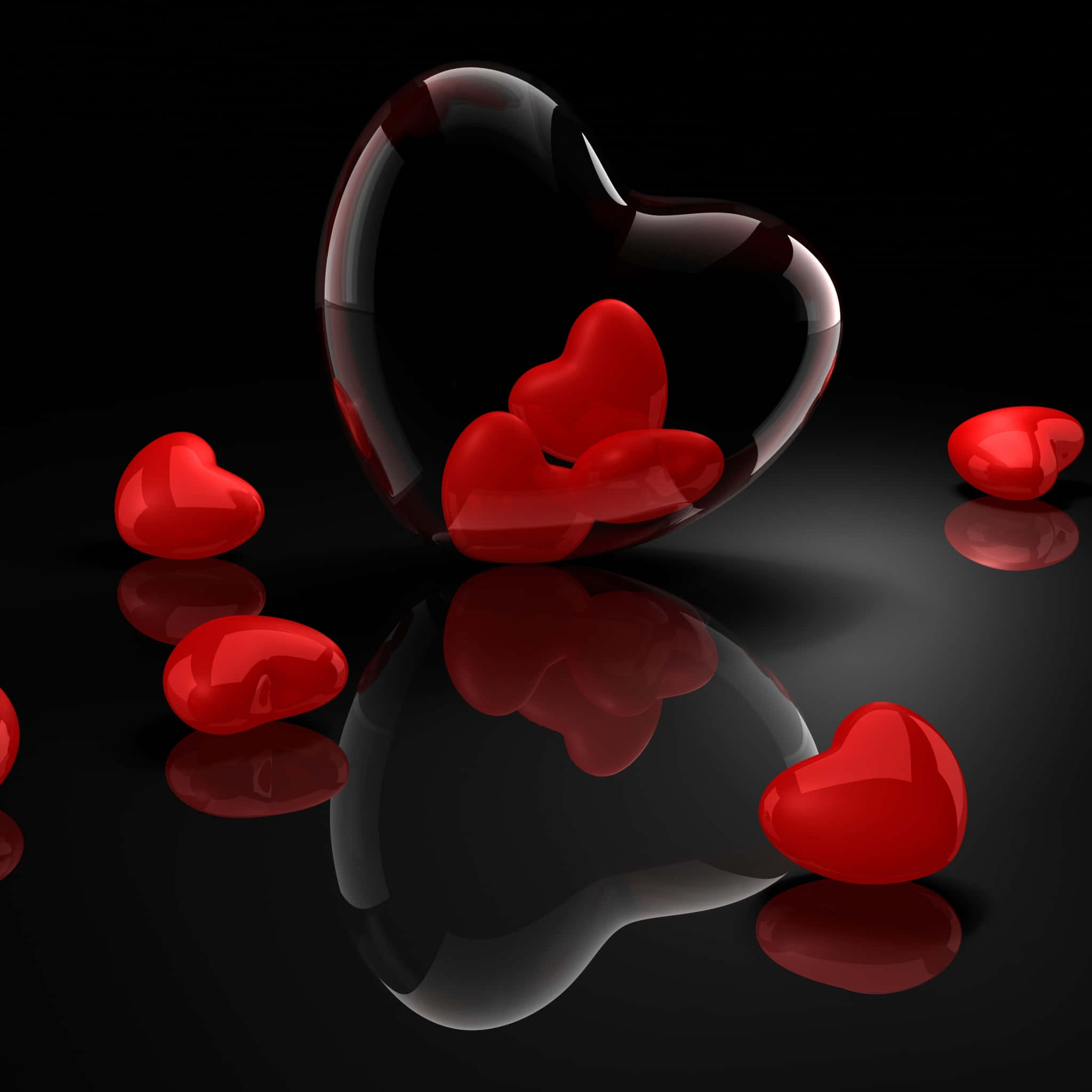Cute Hearts 桌布 壁紙 — 各種尺寸的光澤紅色心形圖案放置在反光黑色表面上，一個大的透明心形容器內裝有較小的心形。