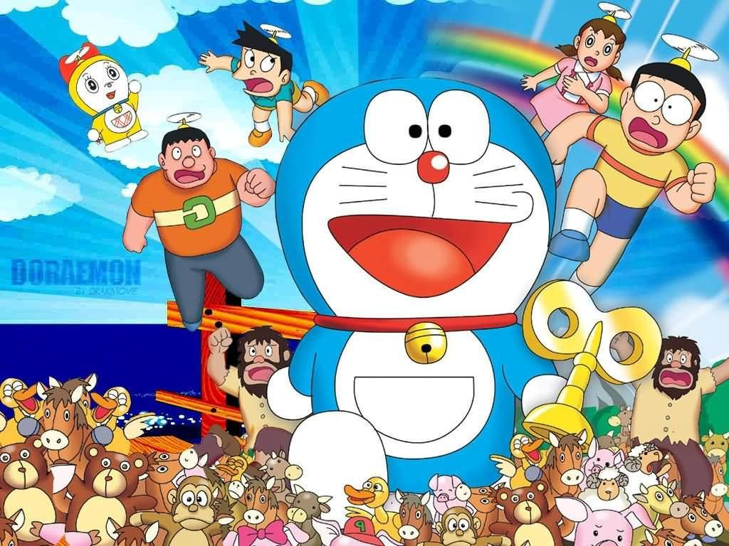Doraemon 桌布 壁紙 — 哆啦A夢和他的朋友們愉快地在明亮的藍天中翱翔，身後有彩虹，下方圍繞著一群動畫動物。