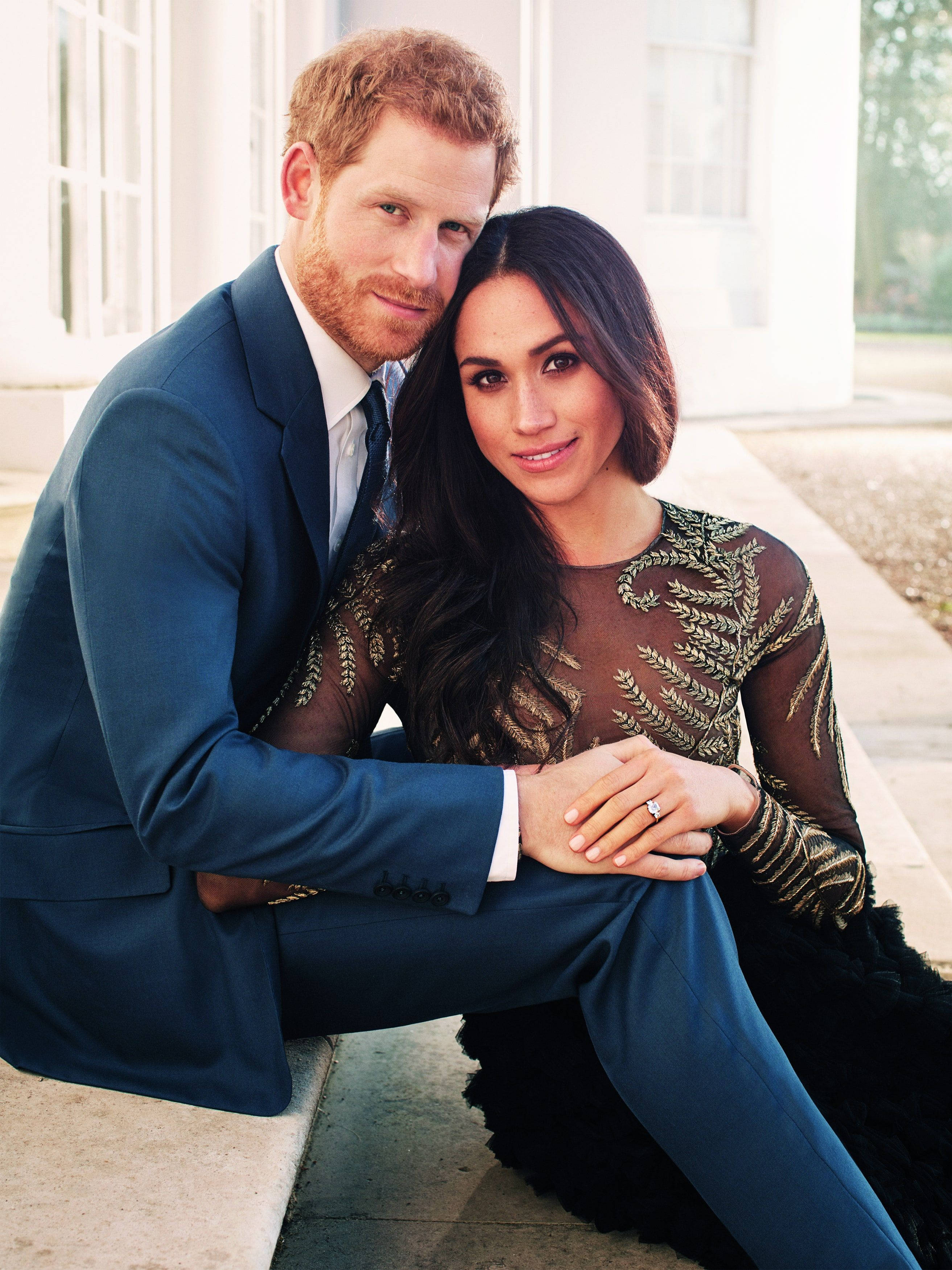 Meghan Markle 桌布 壁紙 — 哈利王子與梅根馬克爾緊靠著坐在白色建築前的石階上，對著鏡頭溫暖微笑。