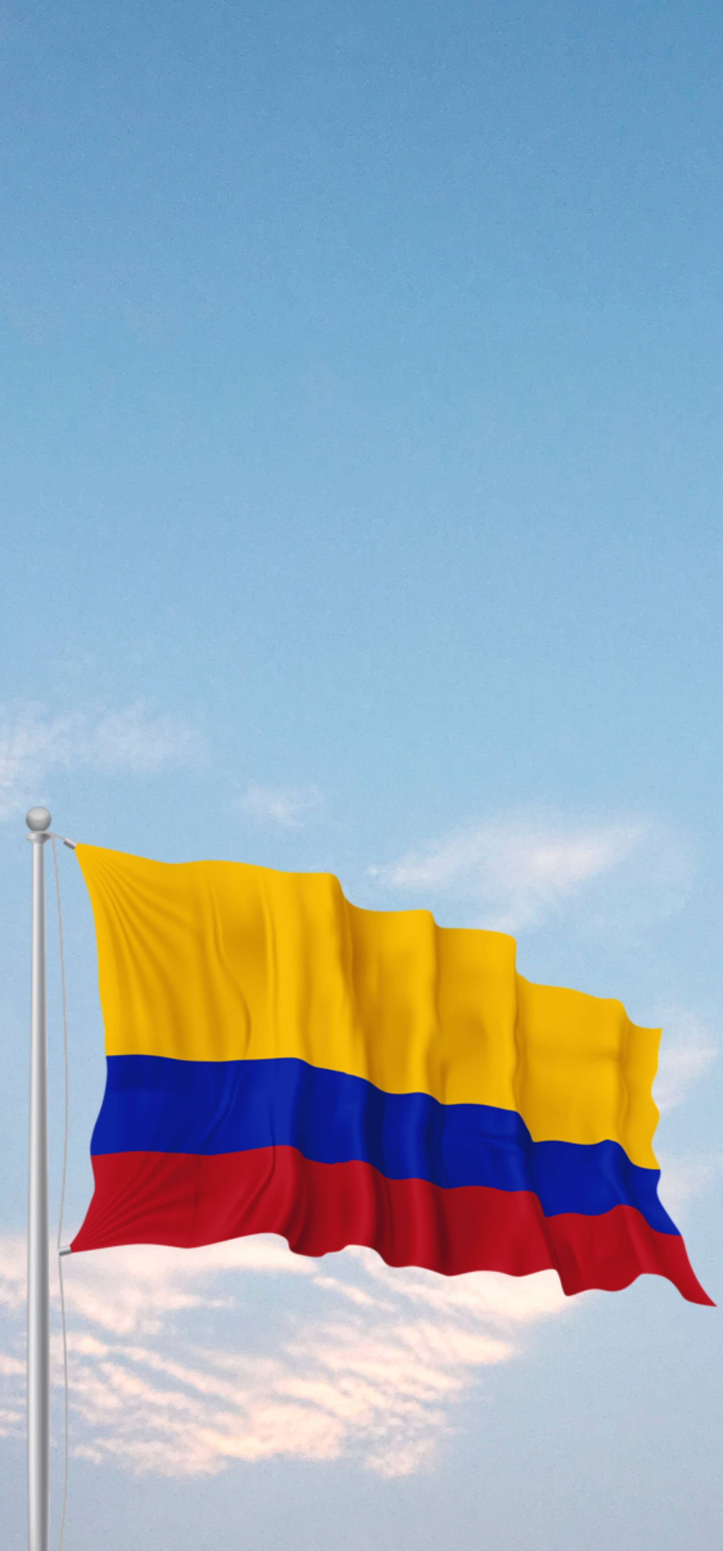 Colombia Flag 桌布 壁紙 — 哥倫比亞國旗在清澈的藍天和柔軟的白雲中自豪地飄揚。