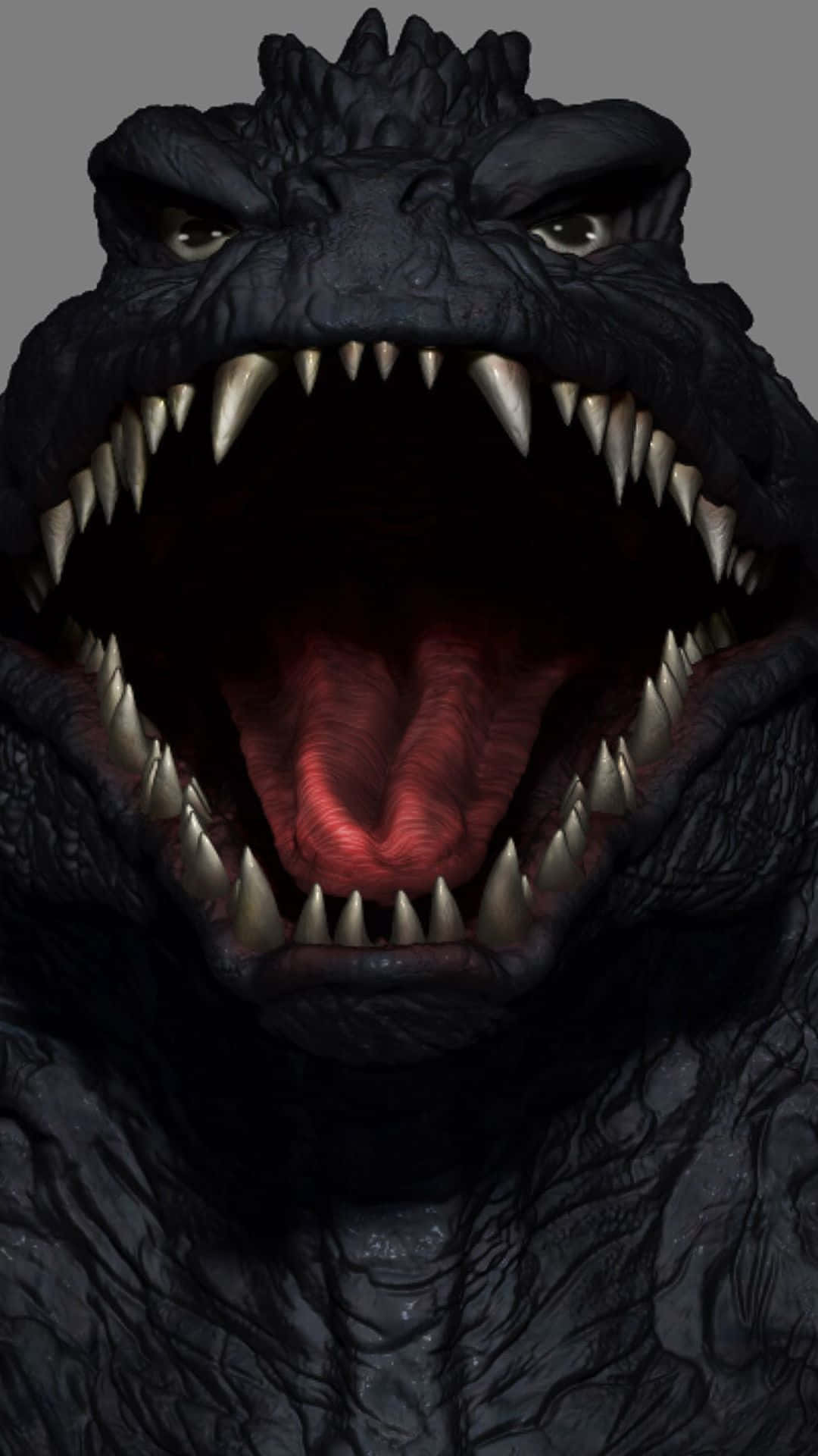 Godzilla 2000 桌布 壁紙 — 哥吉拉咆哮頭部的威脅性特寫，眼睛發光，牙齒鋒利，背景為灰色。