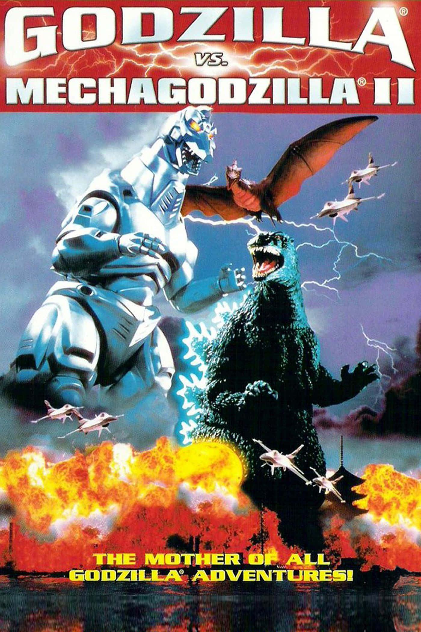 Godzilla Vs Mechagodzilla 桌布 壁紙 — 哥吉拉在燃燒的城市景觀上空與機械哥吉拉II戰鬥，伴隨著熾熱的爆炸和閃電，還有戰鬥機。