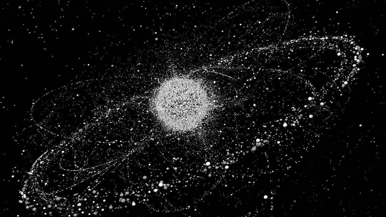Space Debris 桌布 壁紙 — 單色宇宙場景，中央有一顆明亮的恆星，周圍環繞著旋轉的粒子軌跡，背景是星空。