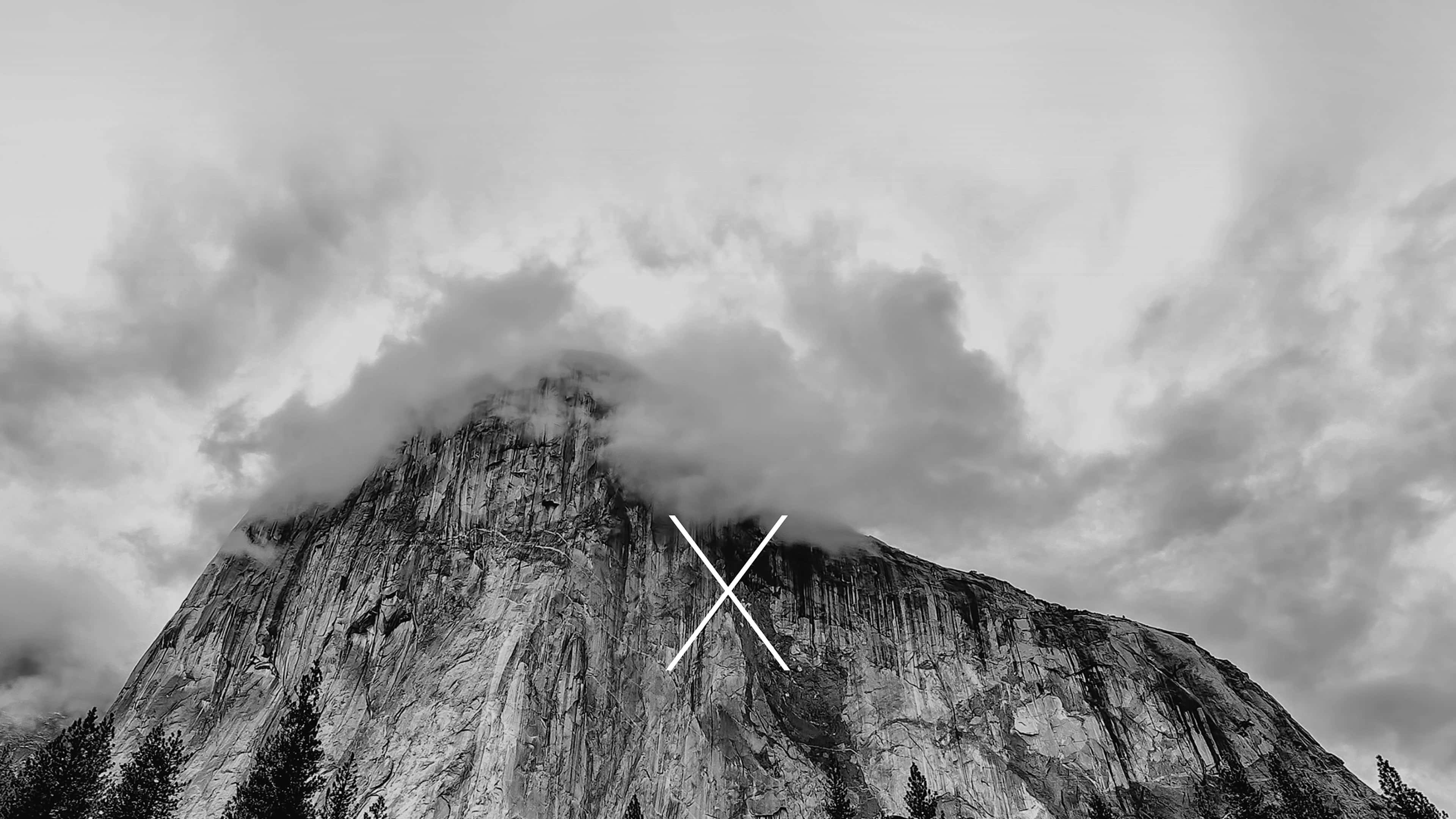 4K Mountain 桌布 壁紙 — 單色山峰部分被戲劇性的雲層遮蓋，帶有極簡白色X疊加層。