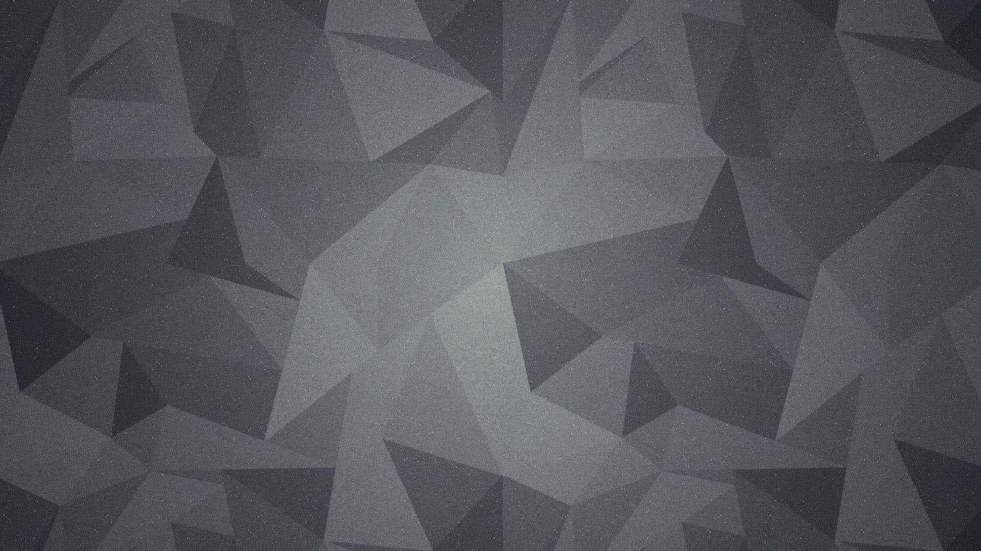 Grey Desktop 桌布 壁紙 — 單色幾何壁紙，帶有低多邊形三角形切面，呈現不同深淺的灰色，營造現代抽象紋理。