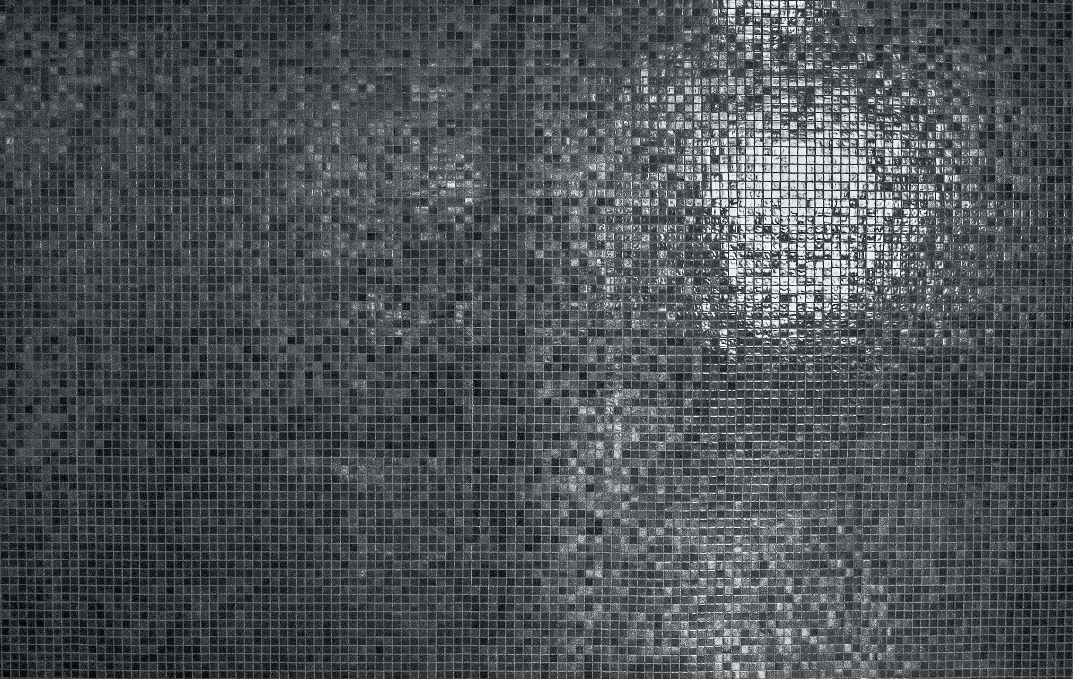 Mosaic 桌布 壁紙 — 單色馬賽克瓷磚牆，明亮的燈光反射在其表面形成閃爍圖案。