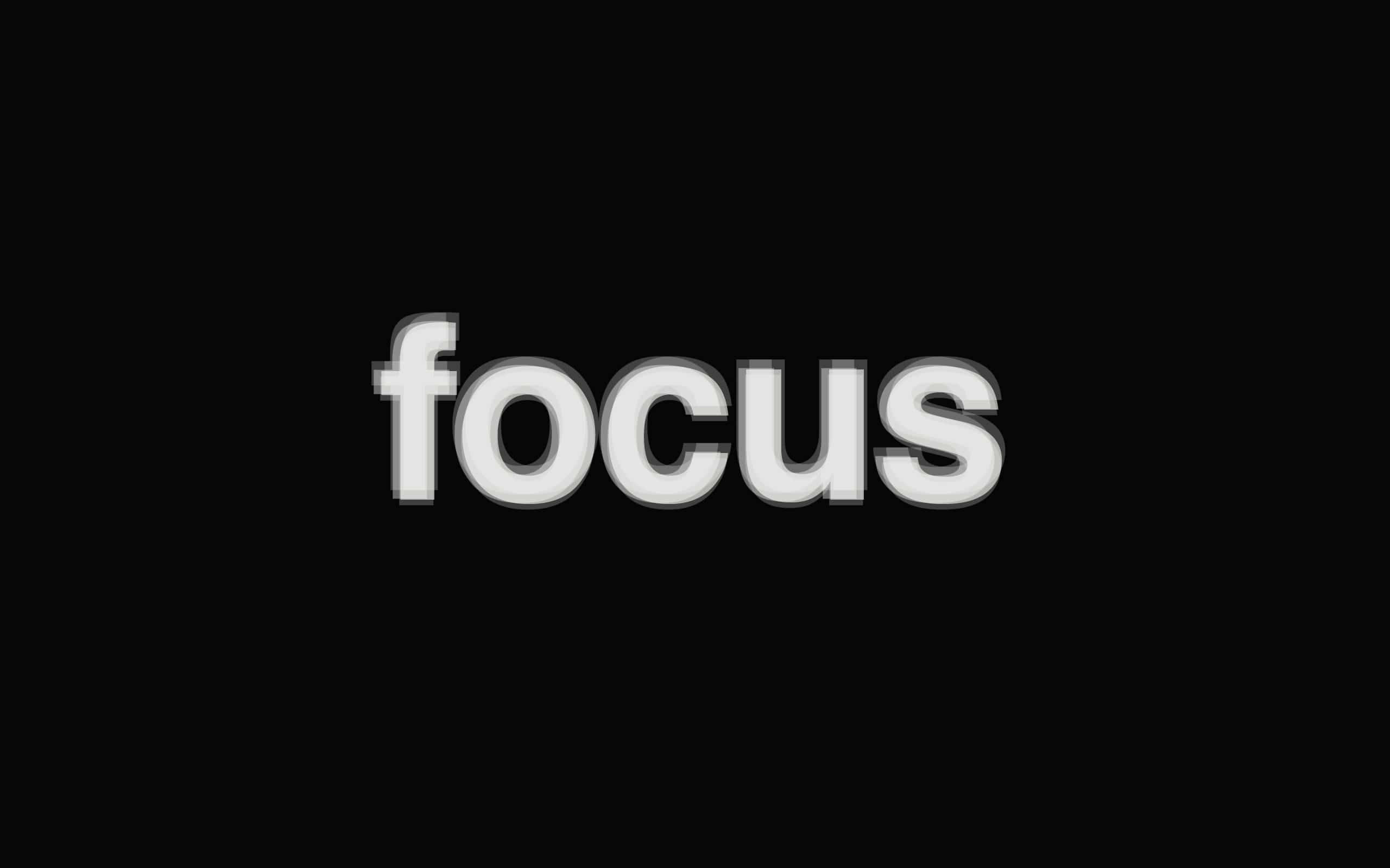 Focus 桌布 壁紙 — 單詞 focus 以粗體白色 3D 字母居中顯示在純黑色背景上。