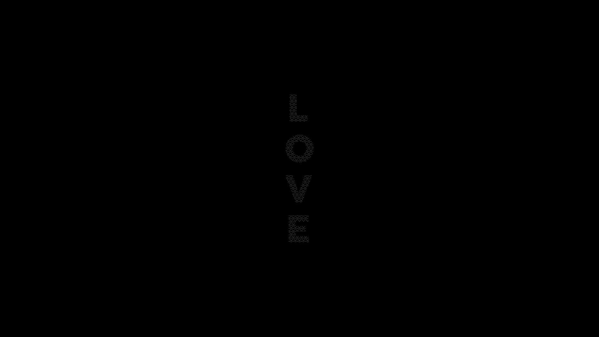 Plain Black Desktop 桌布 壁紙 — 單詞 LOVE 以微弱的灰色點垂直拼寫在純黑色背景上。