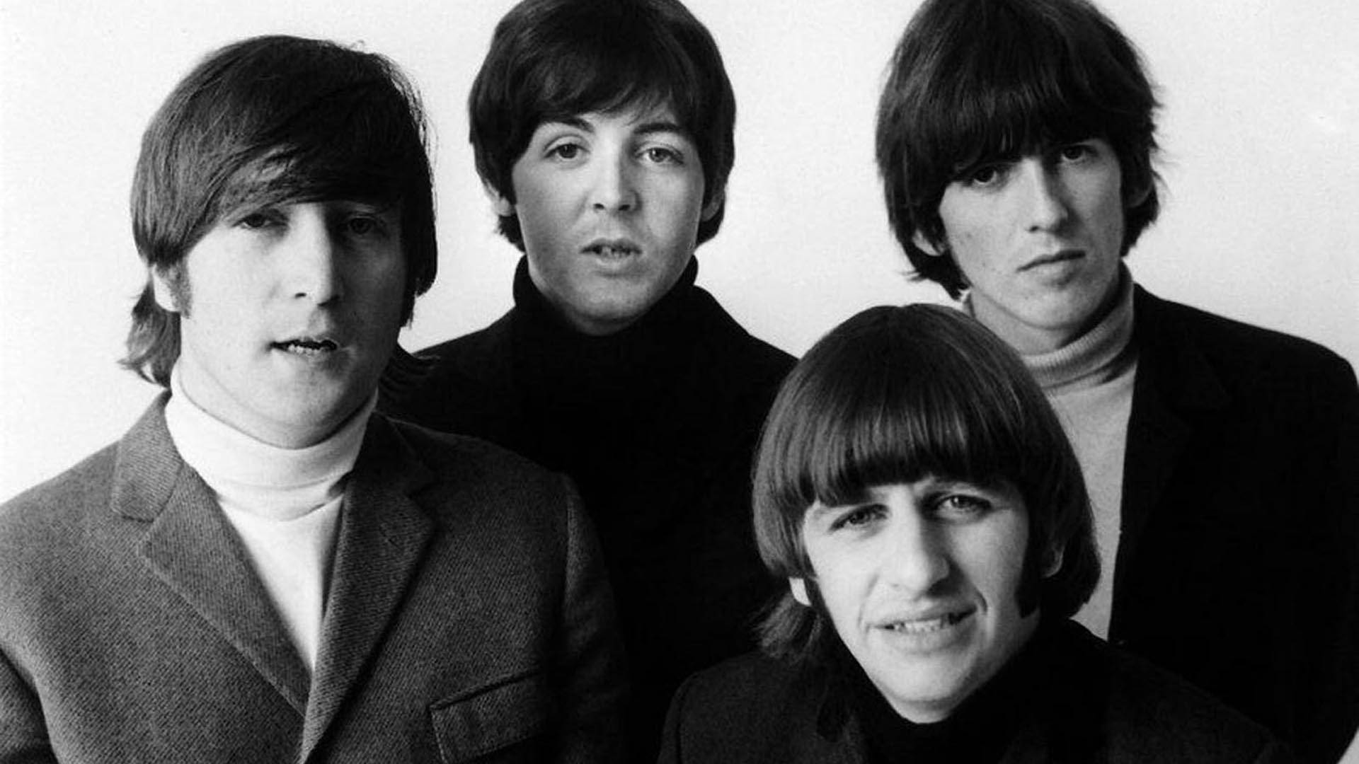the beatles 桌布 壁紙 — 四位擁有1960年代髮型並穿著高領毛衣的男士，在鮮明的黑白工作室肖像中緊密地擺姿勢。