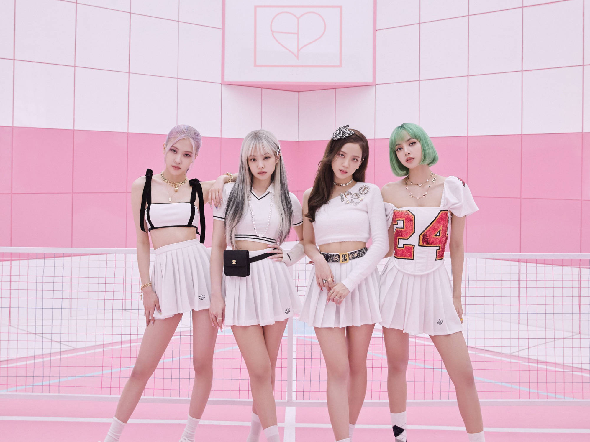 BLACKPINK 桌布 壁紙 — 四位時尚女性，頭髮色彩繽紛，穿著相配的白色服裝，在充滿活力的粉紅色網格牆前自信地擺姿勢。