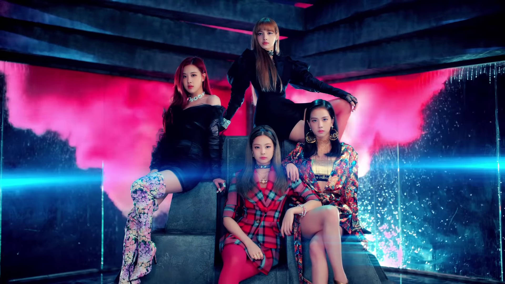 BLACKPINK 桌布 壁紙 — 四位時尚女性在混凝土平台上自信地擺姿勢，背景是發光的粉紅色和藍色霓虹燈。
