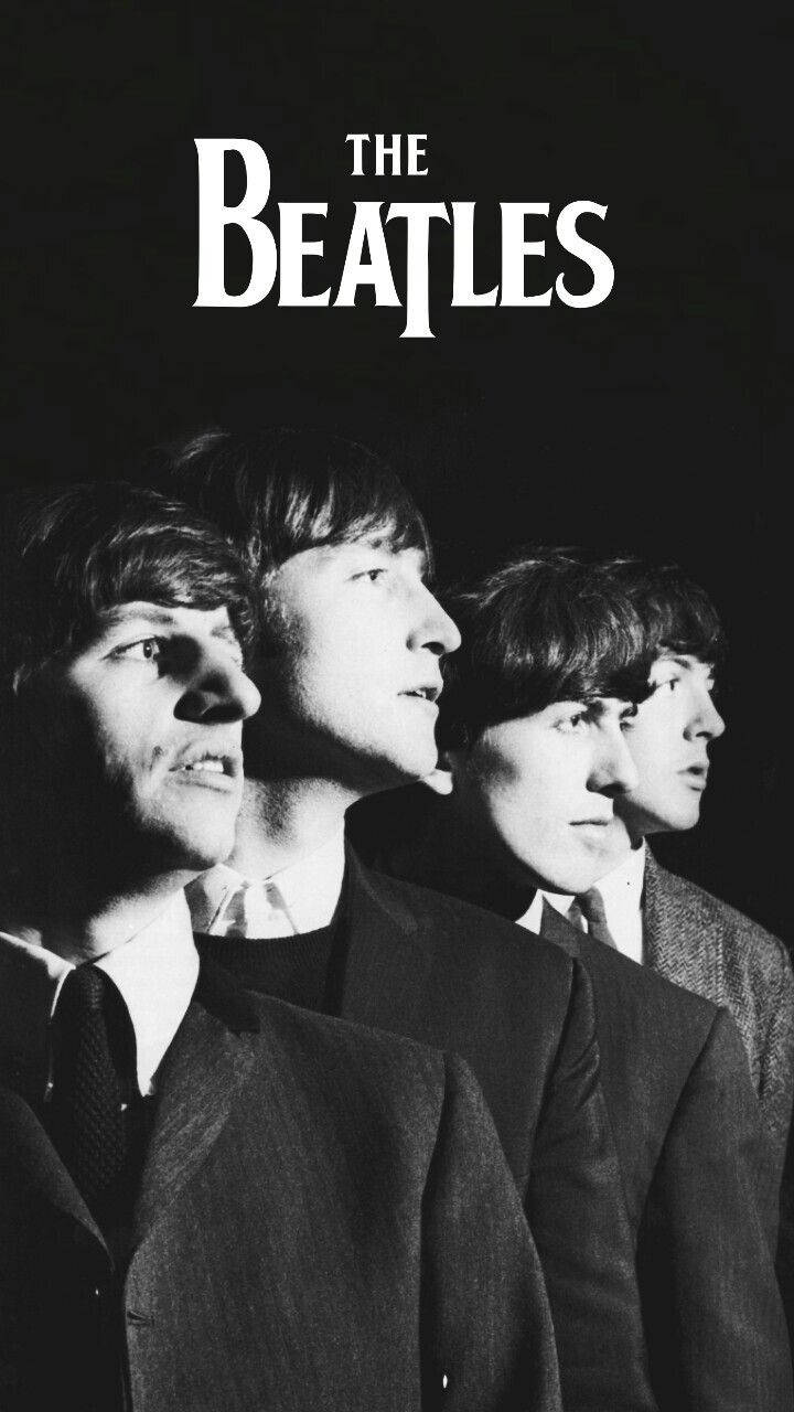 the beatles 桌布 壁紙 — 四位身穿西裝的男子在純黑背景前向上凝視，上方有「THE BEATLES」文字。