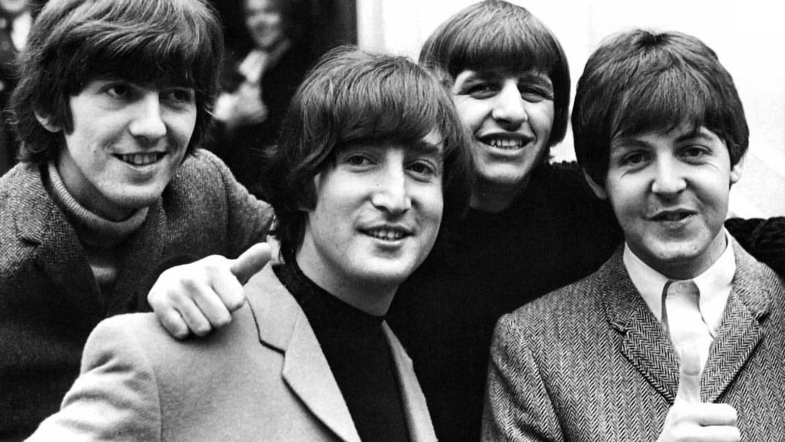 the beatles 桌布 壁紙 — 四位面帶微笑、擁有1960年代髮型的男士在黑白照片中緊密地擺姿勢，互相搭著肩膀。