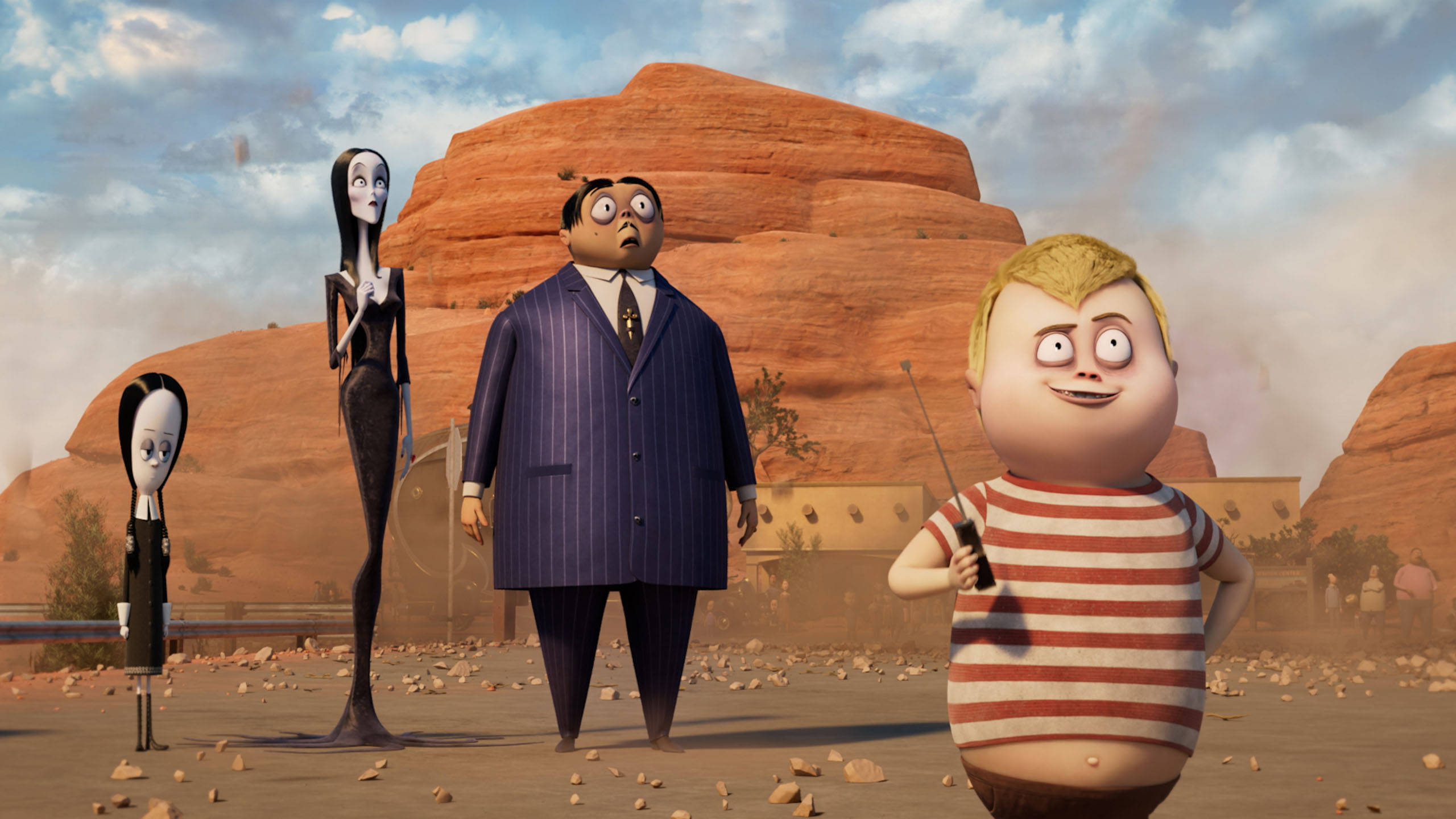 The Addams Family 2 桌布 壁紙 — 四個動畫角色站在一個塵土飛揚的沙漠中，有紅色岩石形成，天空部分多雲。