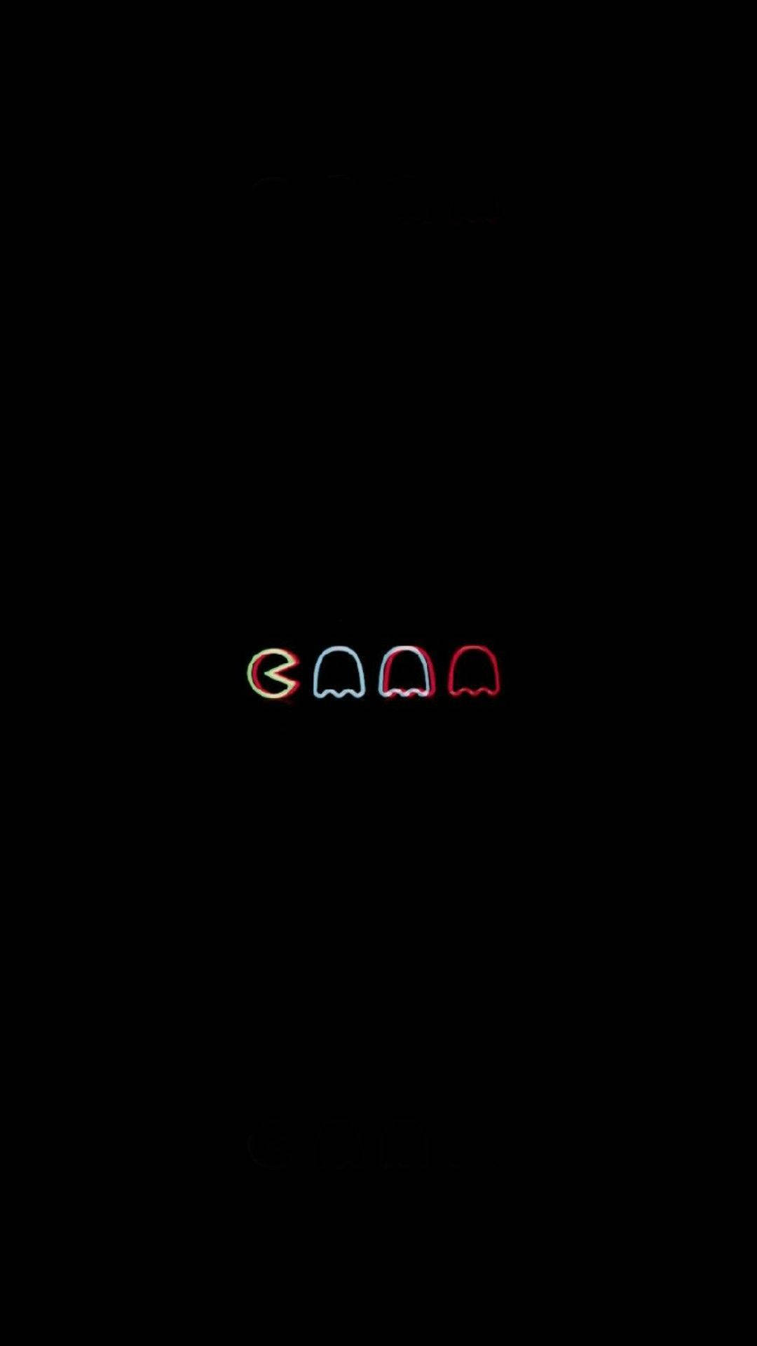 Trippy Dark 桌布 壁紙 — 四個發光的 Pac-Man 鬼魂，以紅、藍、黃色霓虹燈呈現，背景為漆黑一片。