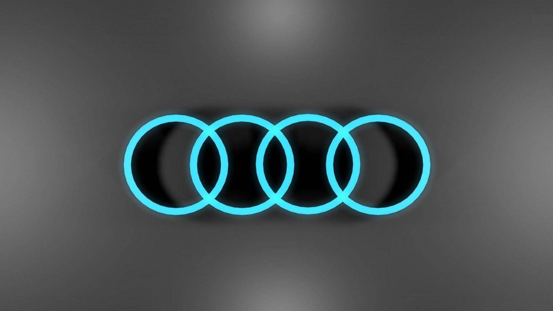 Cool Logos 桌布 壁紙 — 四個發光青色的奧迪標誌連環在平滑的灰色漸變背景上浮動。