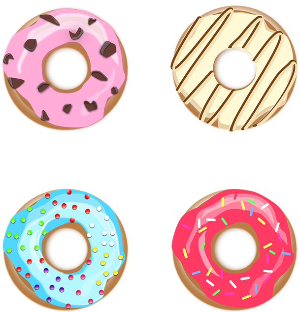 doughnut 桌布 壁紙 — 四個色彩繽紛的卡通甜甜圈，配上粉紅、藍色和米色糖霜及彩針，排列成網格狀。