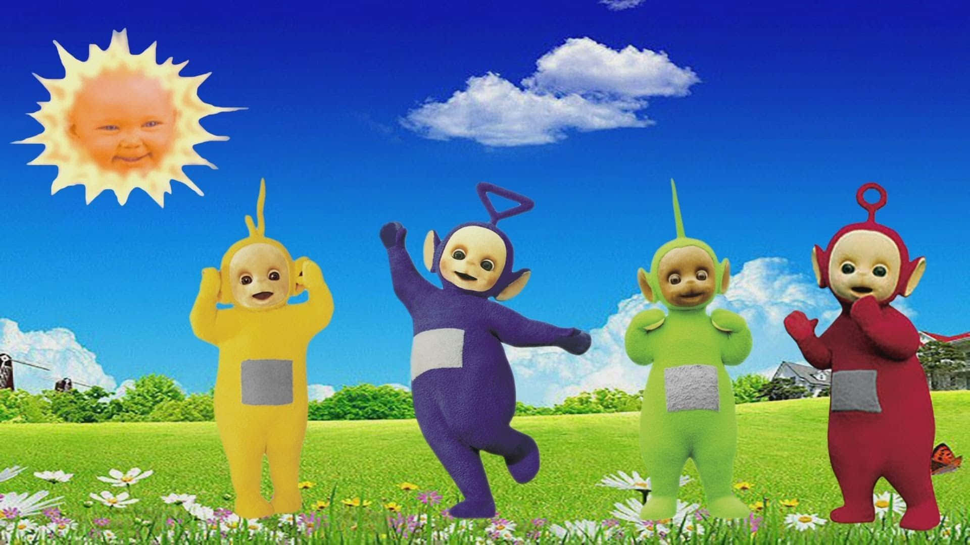 Teletubbies 桌布 壁紙 — 四個色彩繽紛的天線寶寶在陽光明媚的草地上快樂地跳舞，天空湛藍，白雲朵朵。