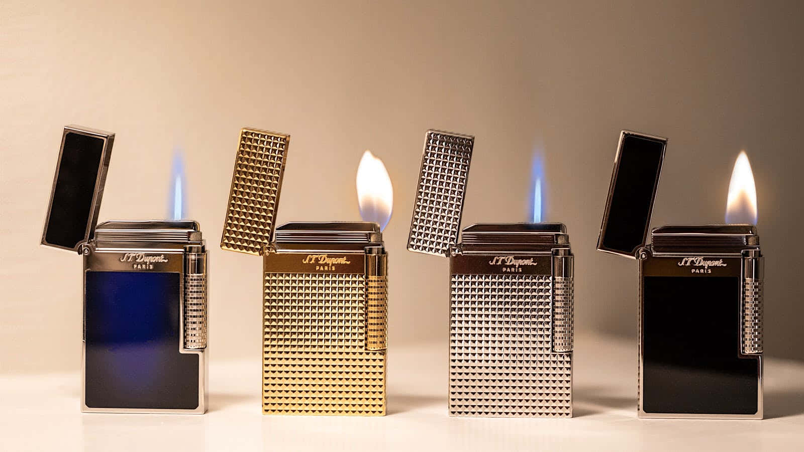 lighter 桌布 壁紙 — 四個豪華打火機在柔和的米色背景上點燃火焰，展示金屬飾面和優雅設計。