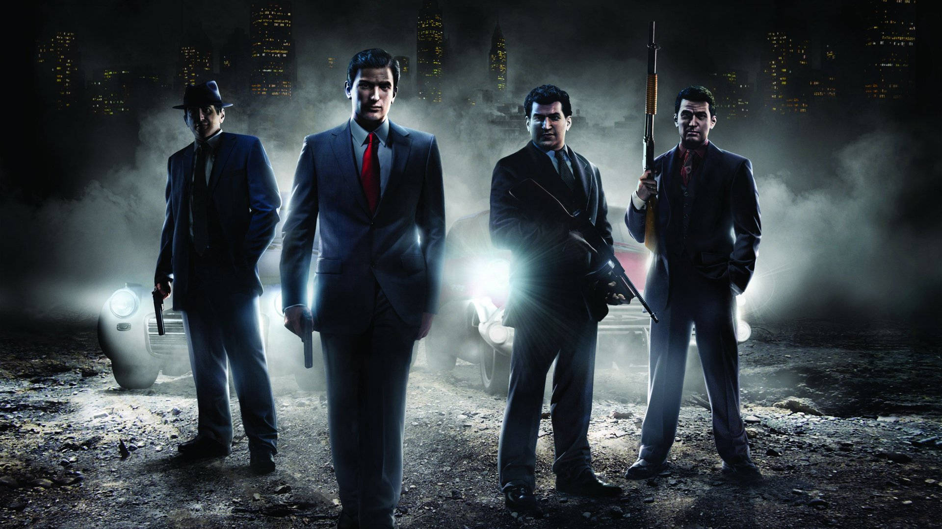 Mafia 桌布 壁紙 — 四個身穿西裝的男人在煙霧瀰漫的城市夜晚中，身後有發光的車頭燈，威嚇地站立著。