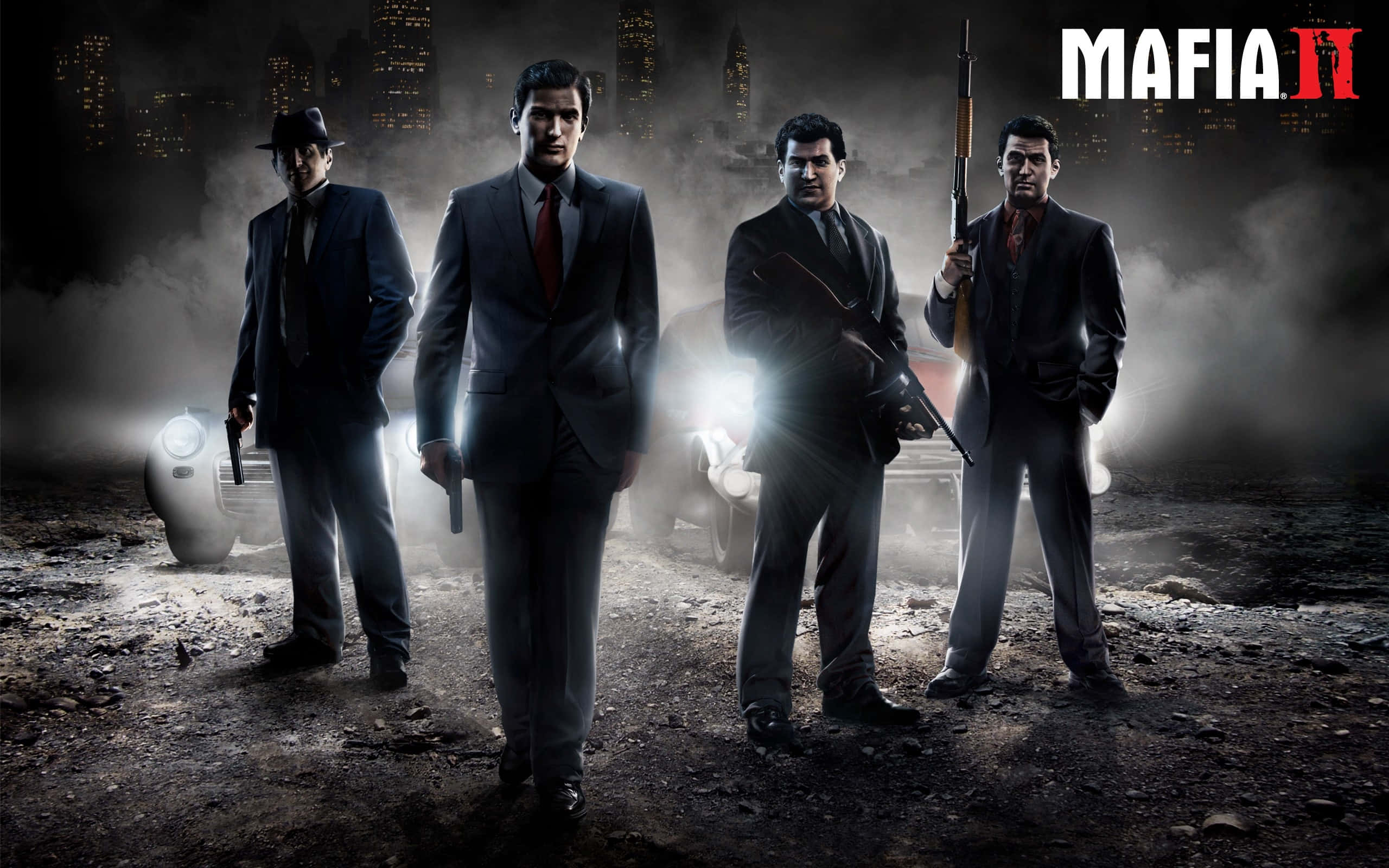 Mafia 桌布 壁紙 — 四個身穿西裝的男人在煙霧瀰漫的城市夜景中，身後有發光的車頭燈，威嚇地站立著。