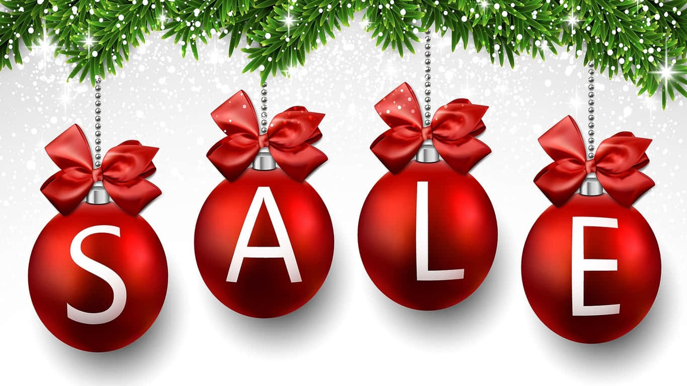 Sales 桌布 壁紙 — 四個閃亮的紅色聖誕裝飾品用白色字母拼出SALE，飾有蝴蝶結，懸掛在綠色松枝下，背景是雪景。