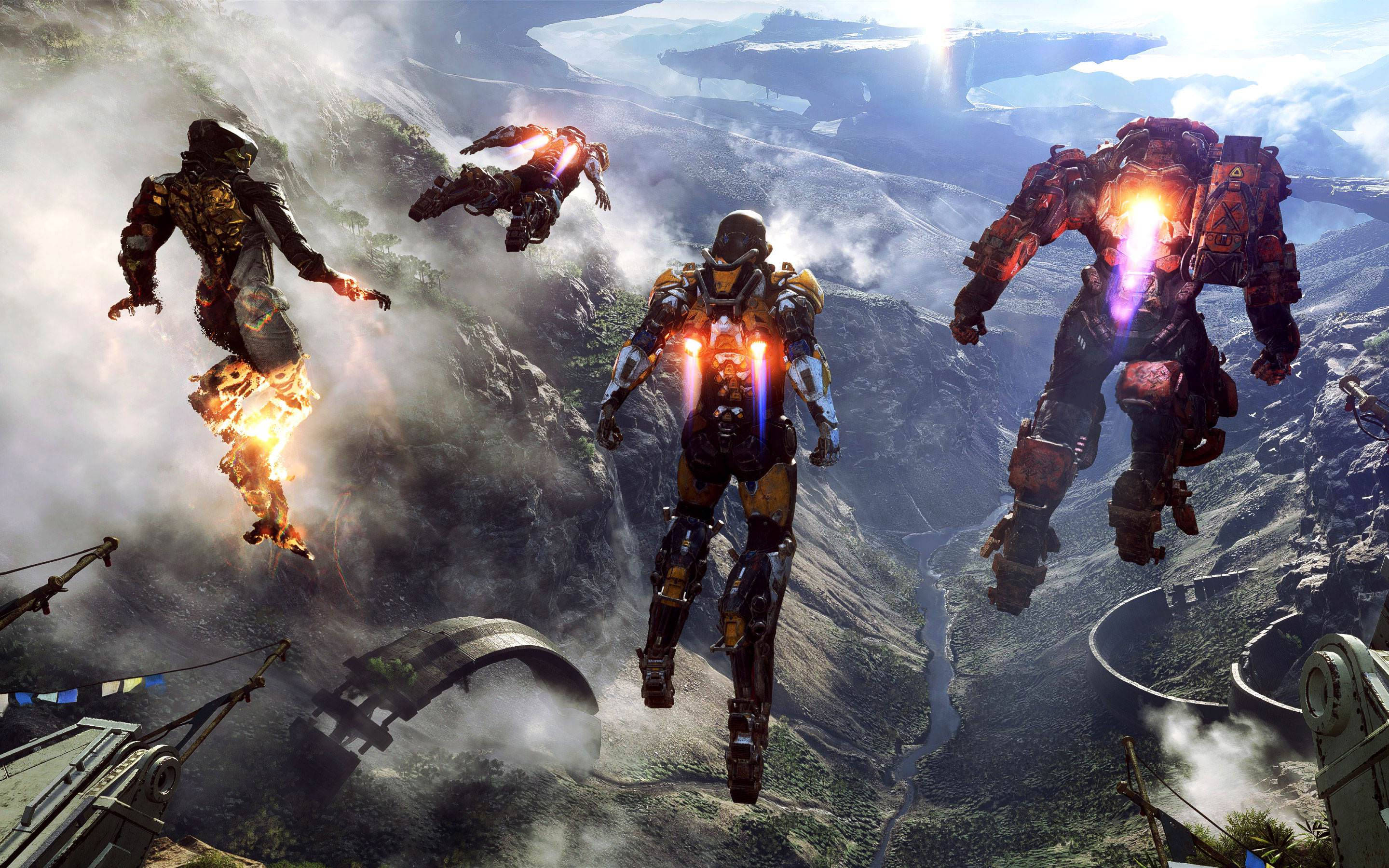 anthem 4K 桌布 壁紙 — 四名裝甲戰士穿過霧氣瀰漫的山峽谷，身後伴隨著發光的推進器和熾熱的爆炸。