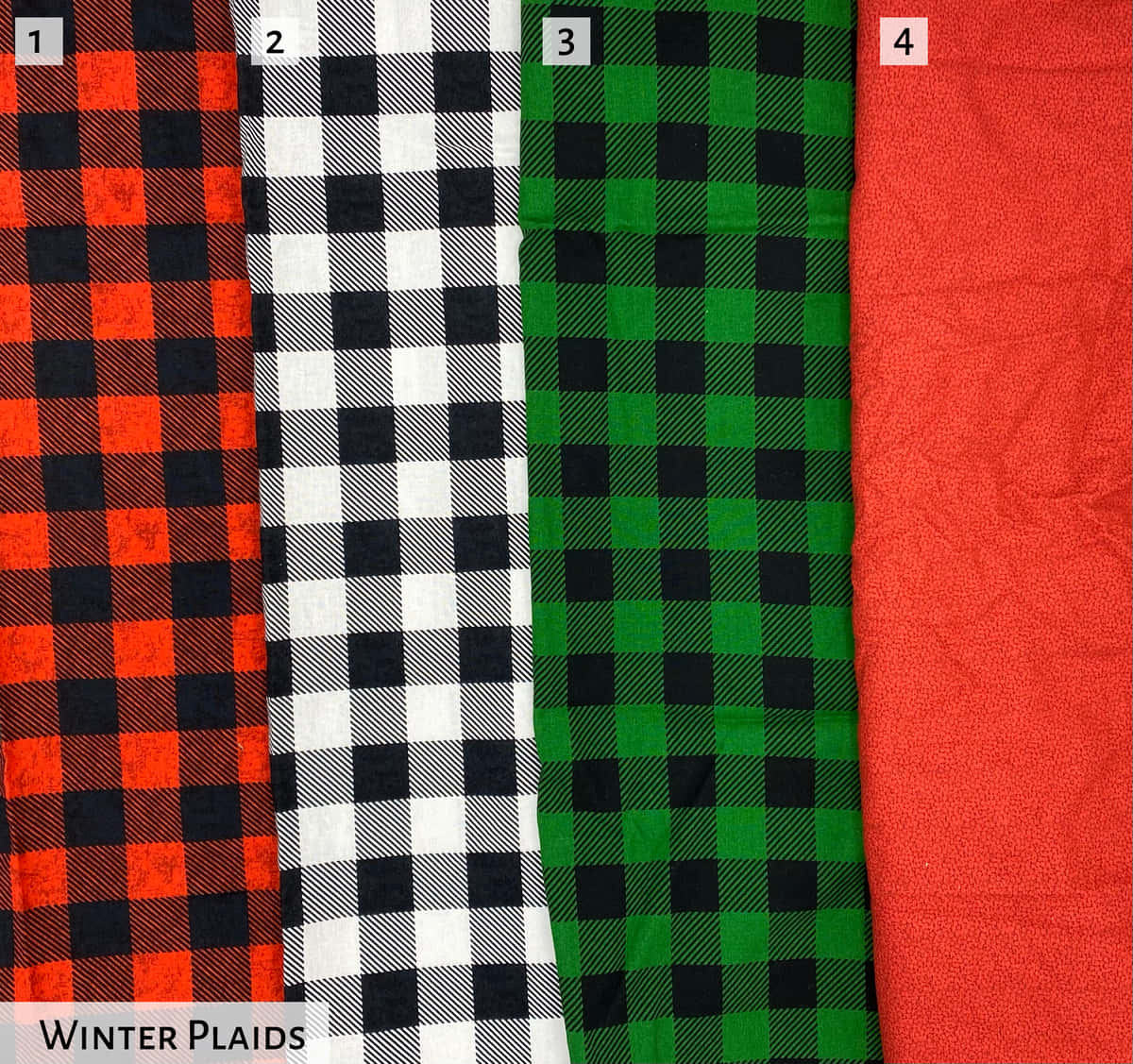 Fabric 桌布 壁紙 — 四塊折疊的冬季格子布料，顏色分別為紅色、黑色、白色、綠色和純紅色，並排展示。