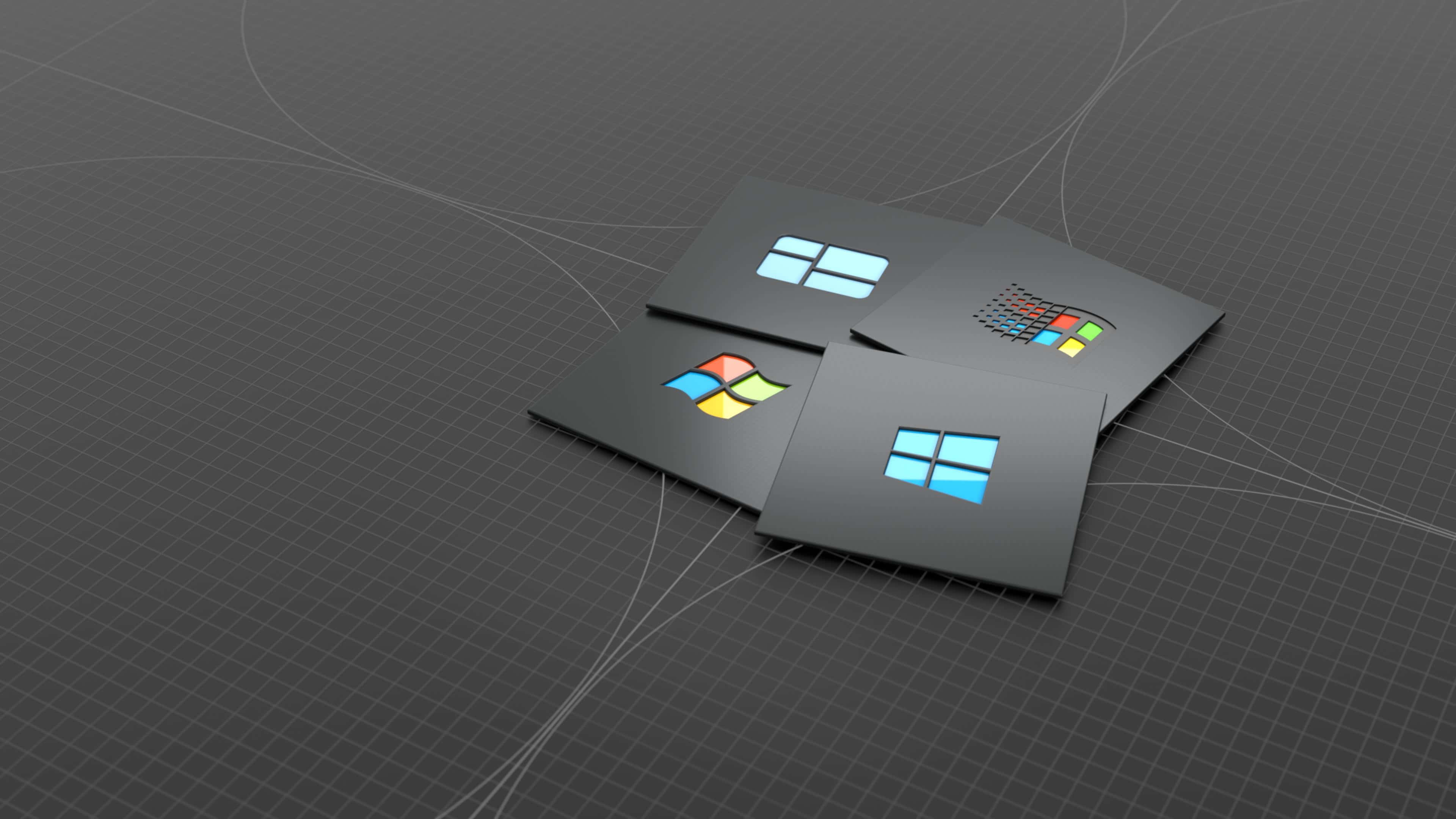 品牌 桌布 壁紙 — 四張帶有 Microsoft Windows 標誌的時尚黑色卡片，放置在帶有發光曲線的深色網格表面上。