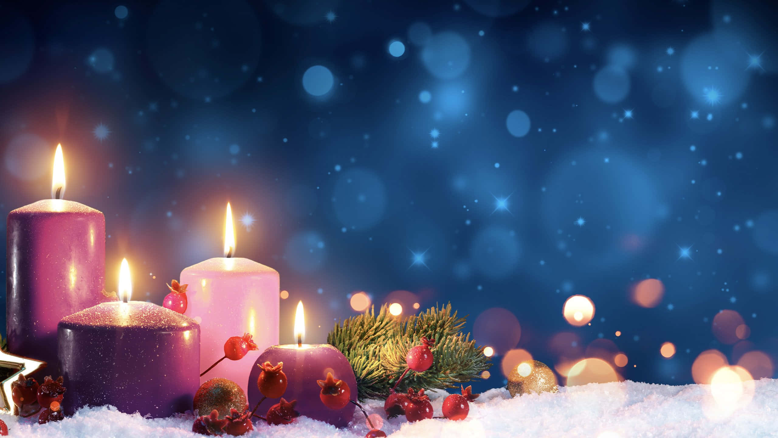 Advent 桌布 壁紙 — 四根點燃的紫色蠟燭在雪地上溫暖地發光，旁邊有松枝和紅色漿果，背景是閃爍的藍色散景。