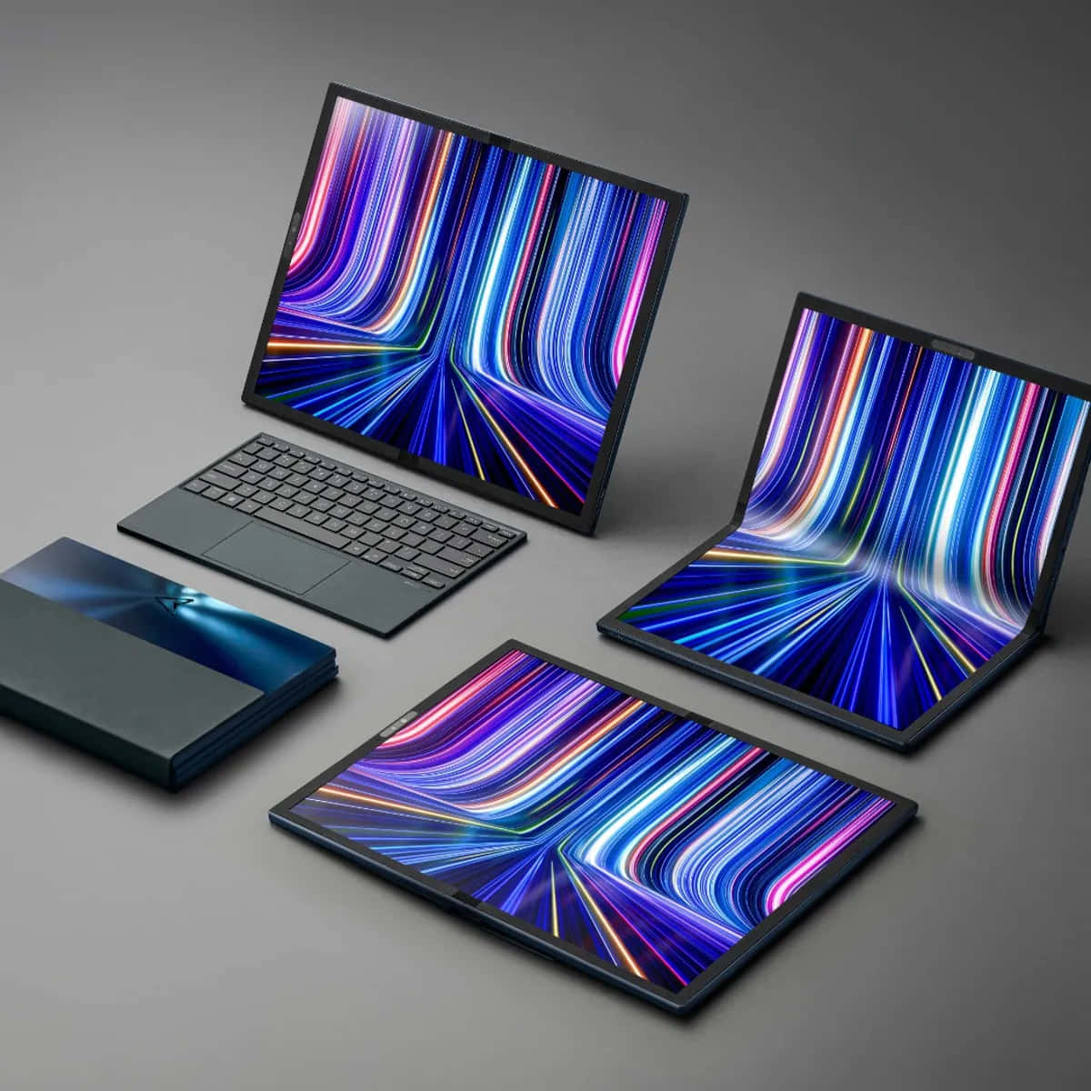 ASUS 桌布 壁紙 — 四款時尚的未來主義筆記型電腦在極簡灰色背景上顯示充滿活力的抽象光條。