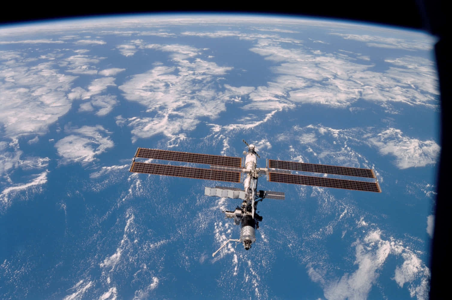 NASA 動態圖片 桌布 壁紙 — 國際太空站繞地球運行，顯示藍色海洋、白色雲層和從太空看到的彎曲地平線。